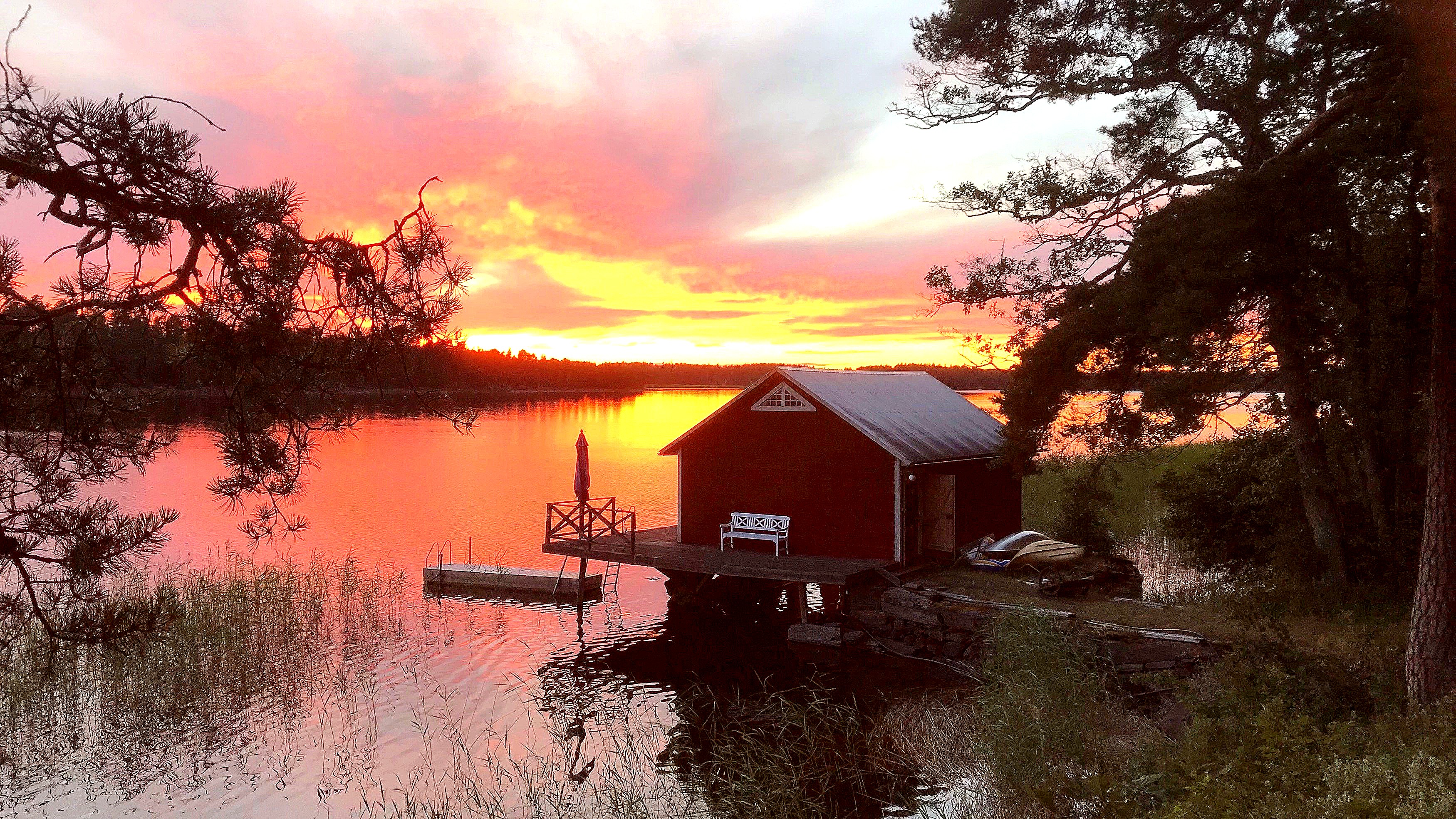 A beautiful sundown over the lake and boat house at Swedish Country Living.