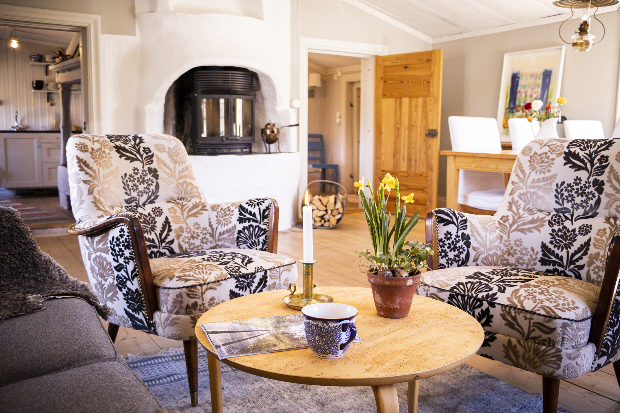 The living room with two armchairs and a stove