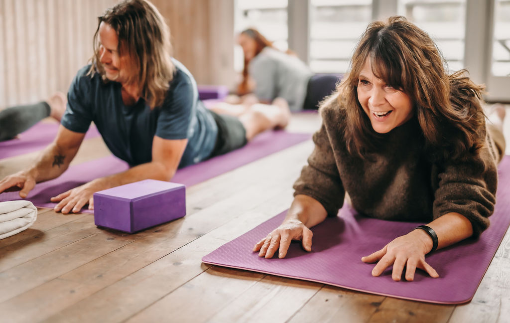 People doing yoga in a yoga studio.
