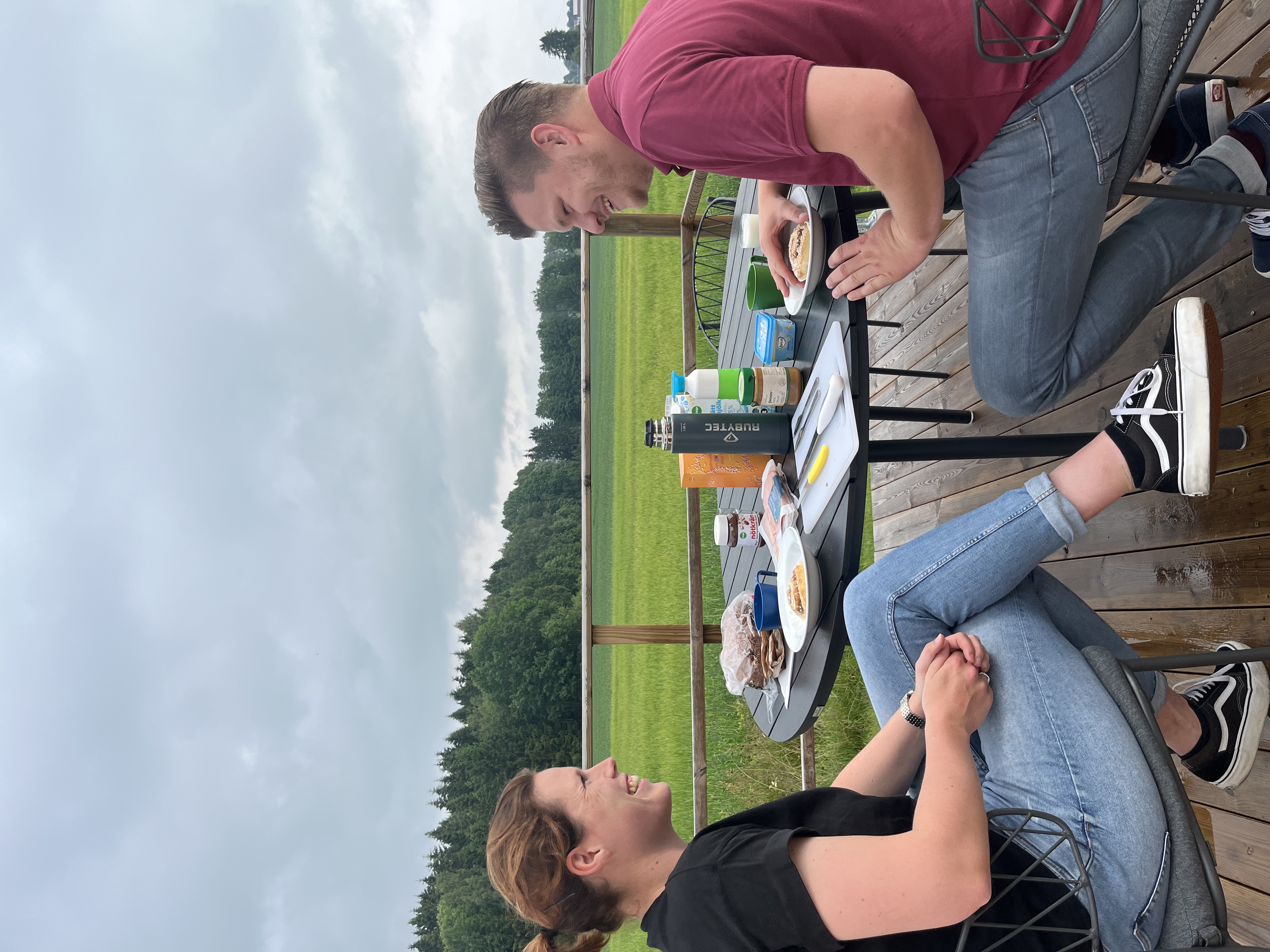 A couple is sitting on the terrace, having breakfast.