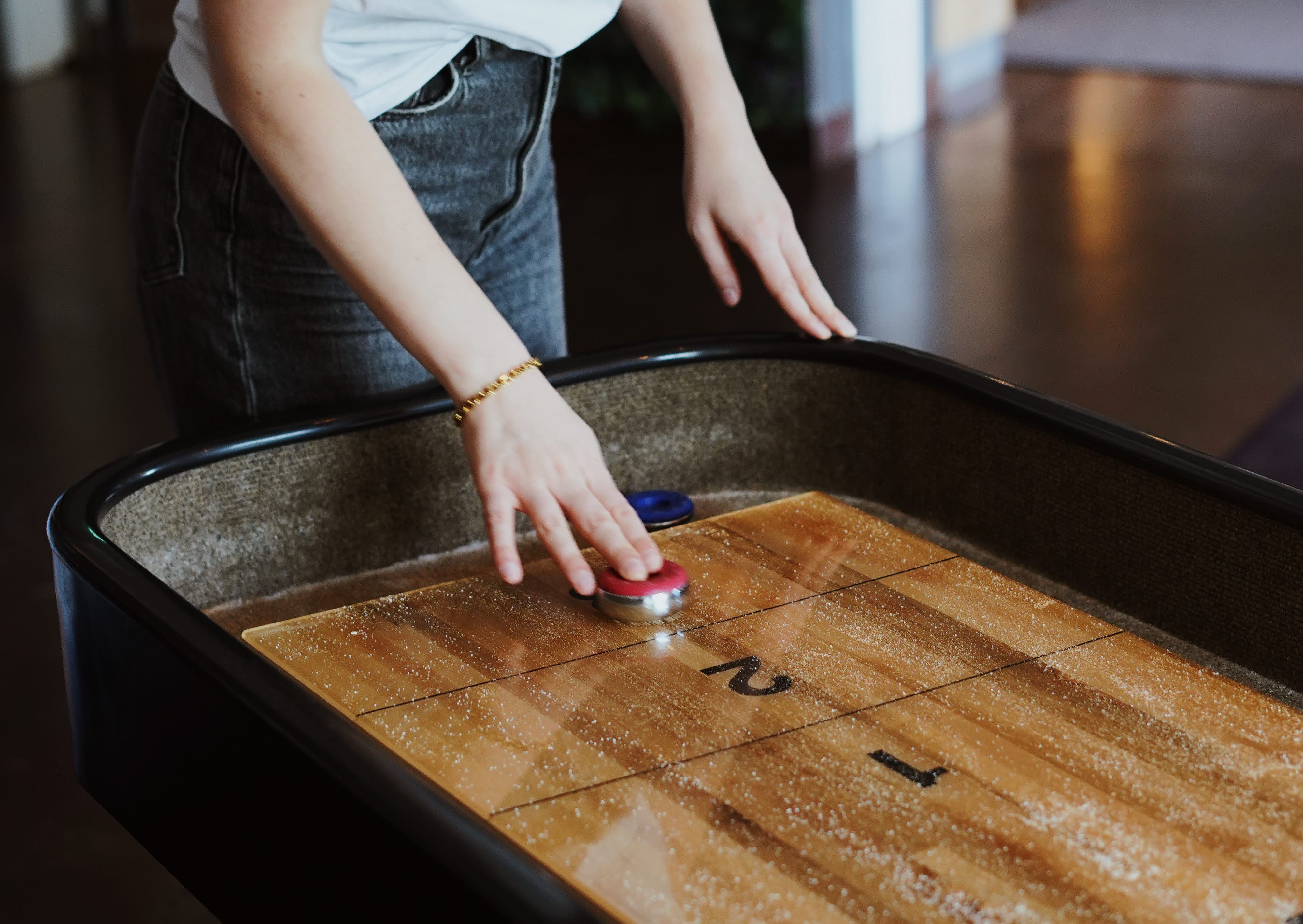 Woman playing shufleboard at Quality Hotel Prisma