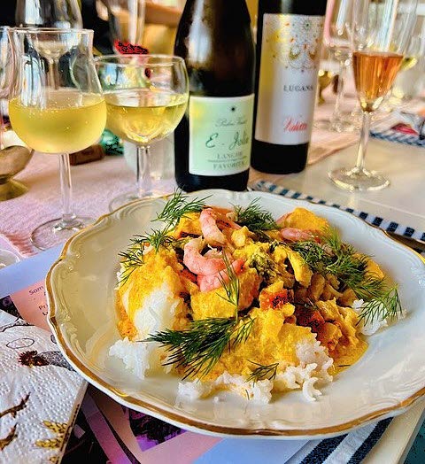 Delicious dish with wine glasses and bottles in the café at Nössemark Camping