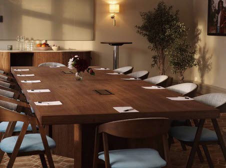 Large conference table with two impressive chandeliers above in a beautiful room at Karstorp Säteri