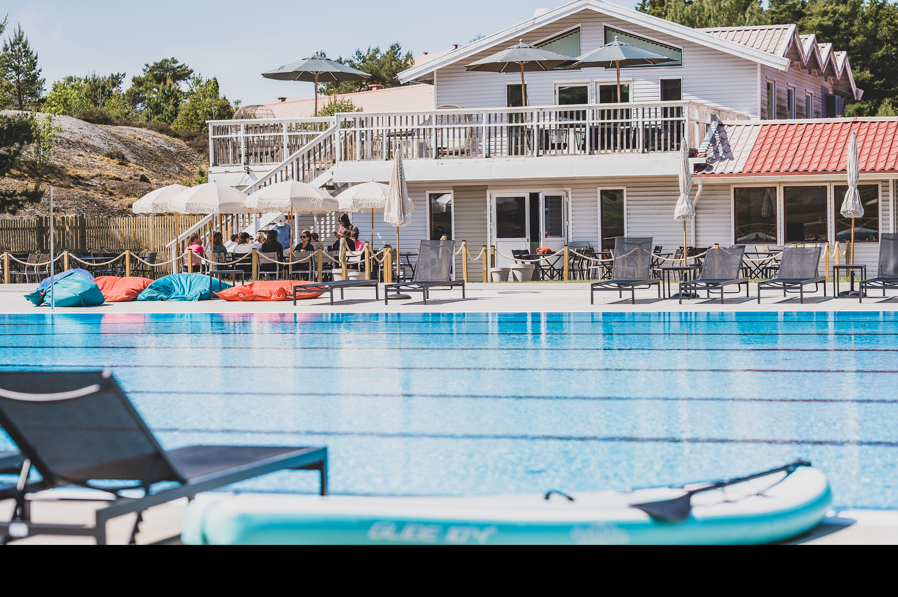 Outside pool area with a white house in the background.