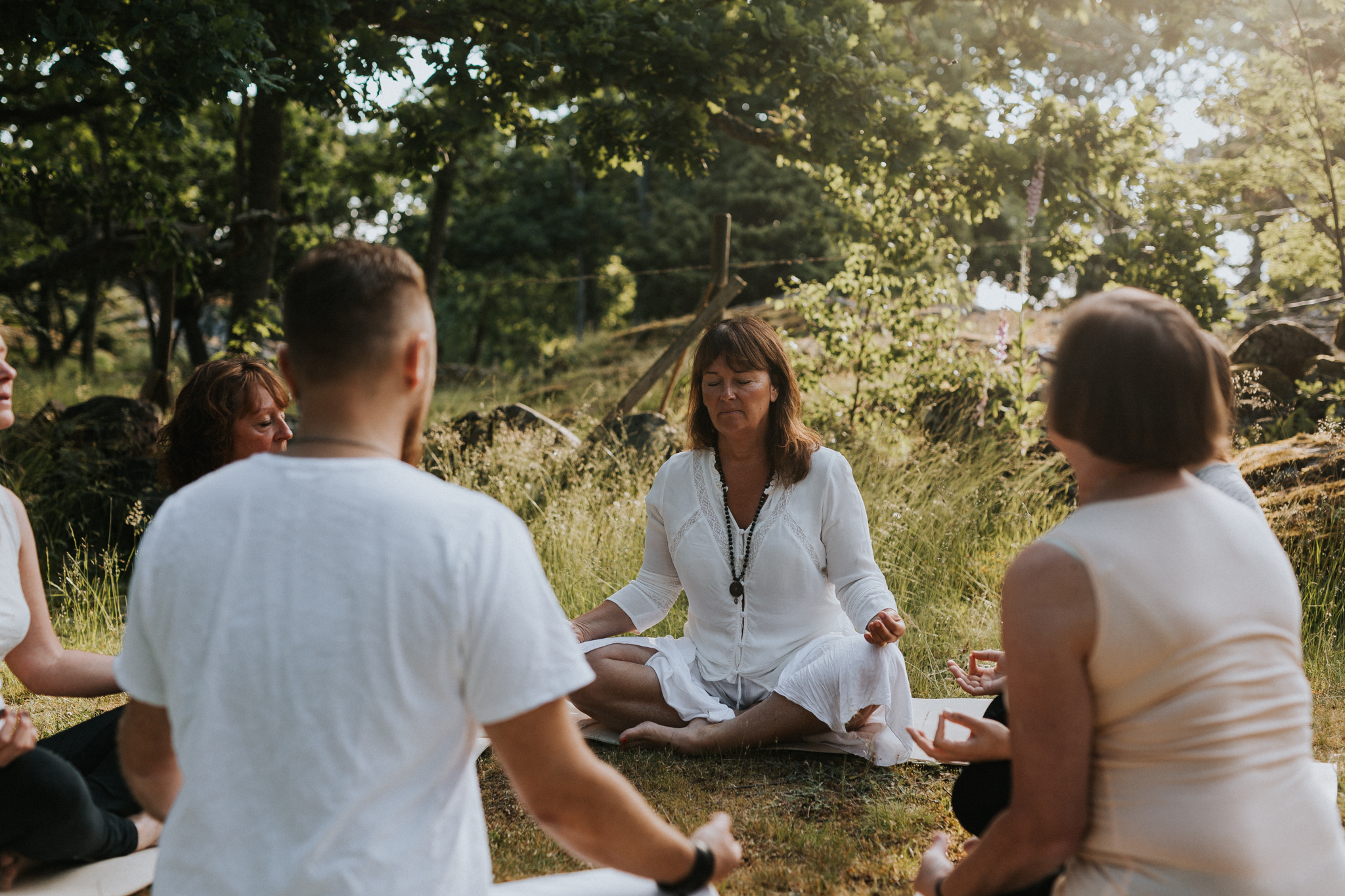 People practicing yoga outside.