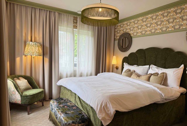 A beautifull hotel suite with a double bed at Karstorp Säteri