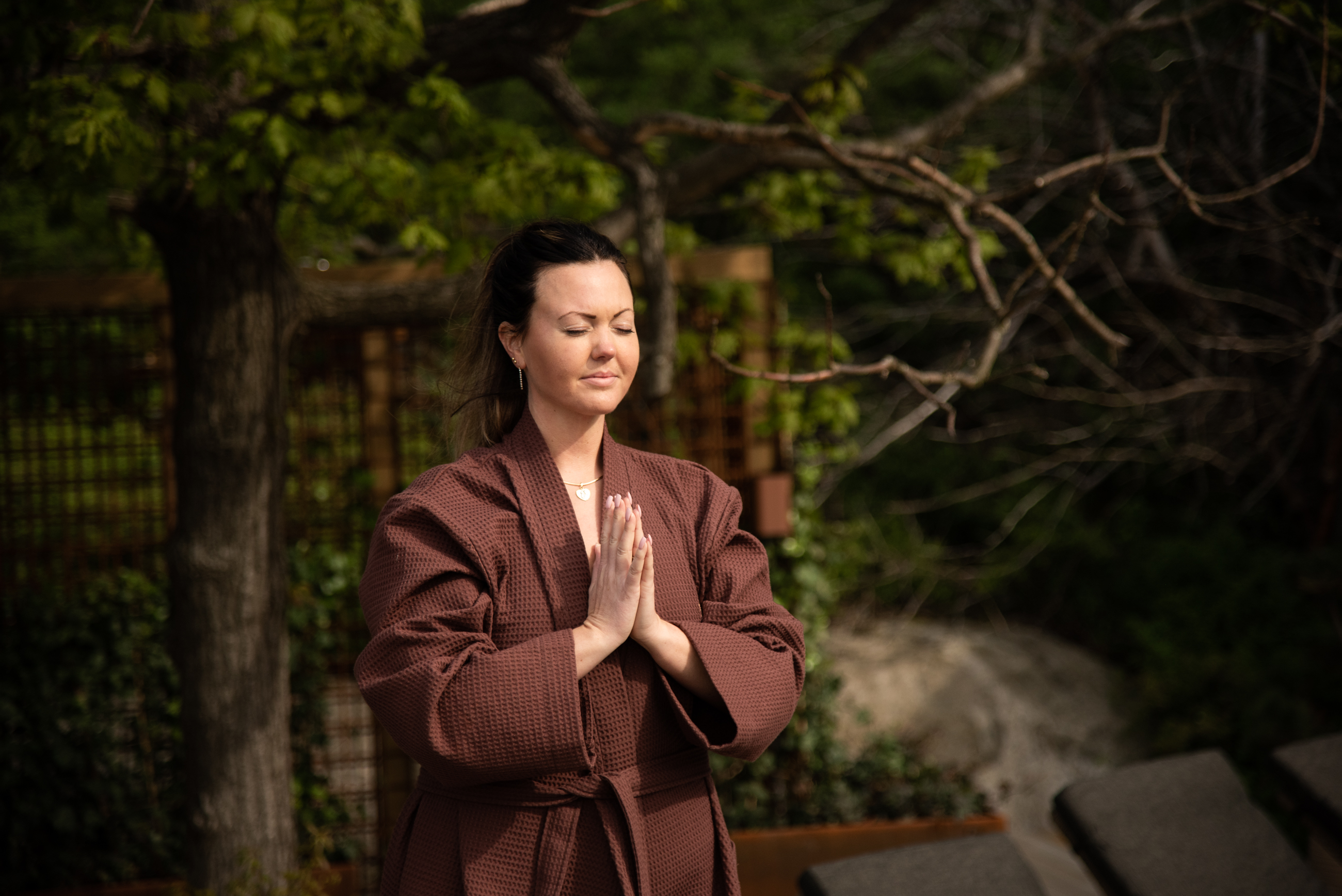 A dark yoga studio with people practicing yoga. 