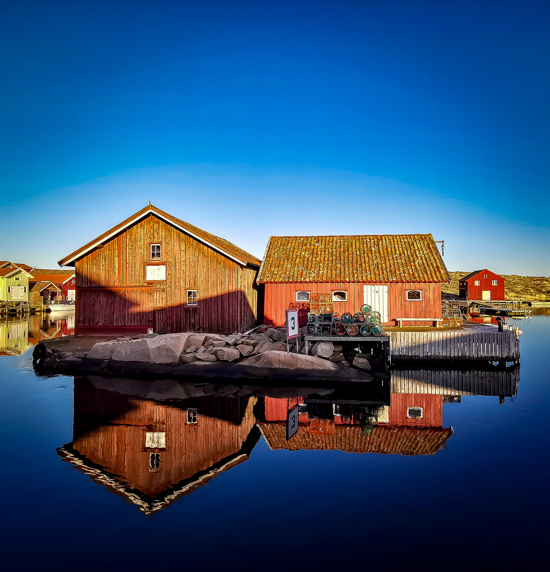 A dark yoga studio with people practicing yoga. 