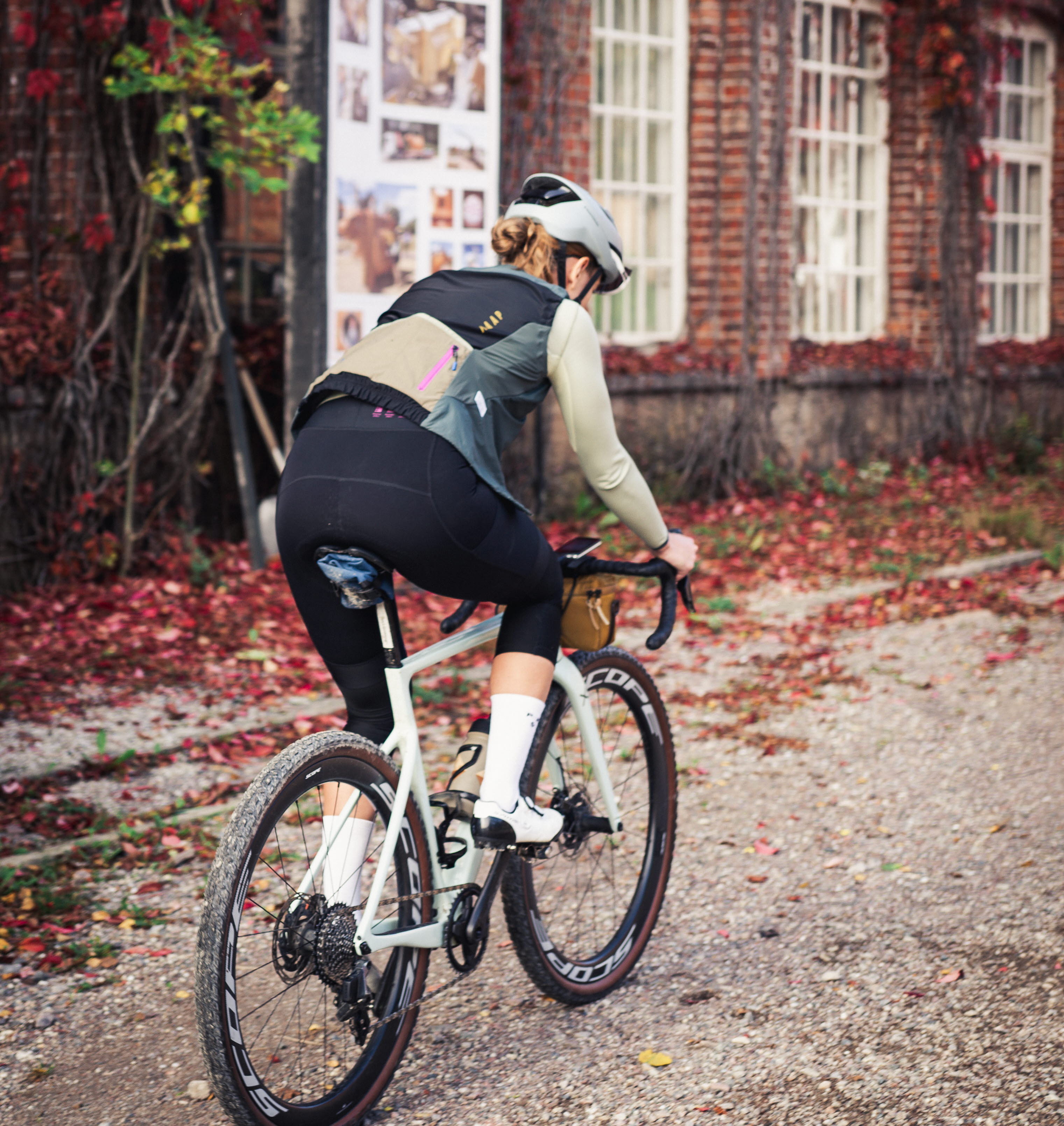 Cyclists on a dirt road in a working environment.