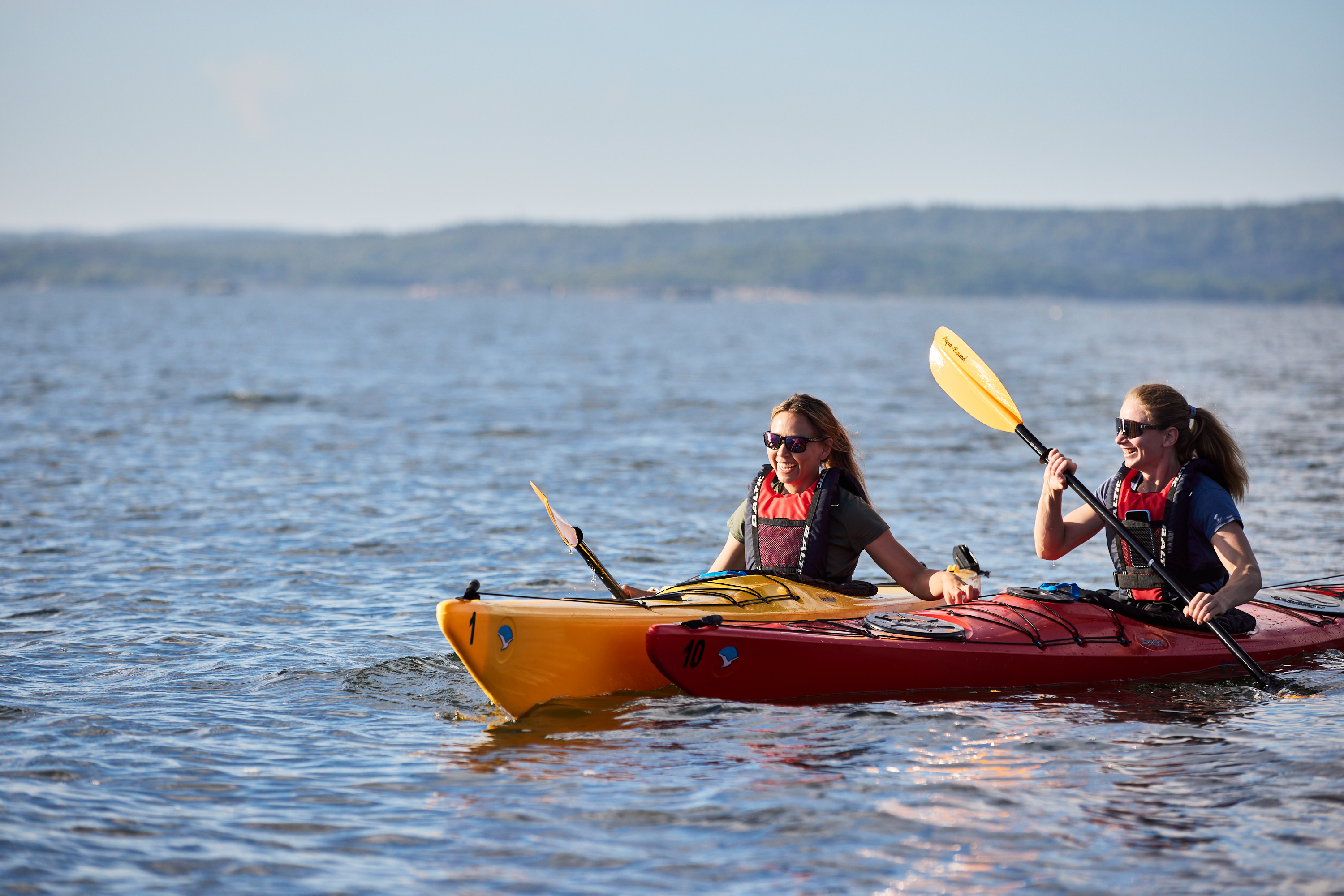 Two women kayaking.