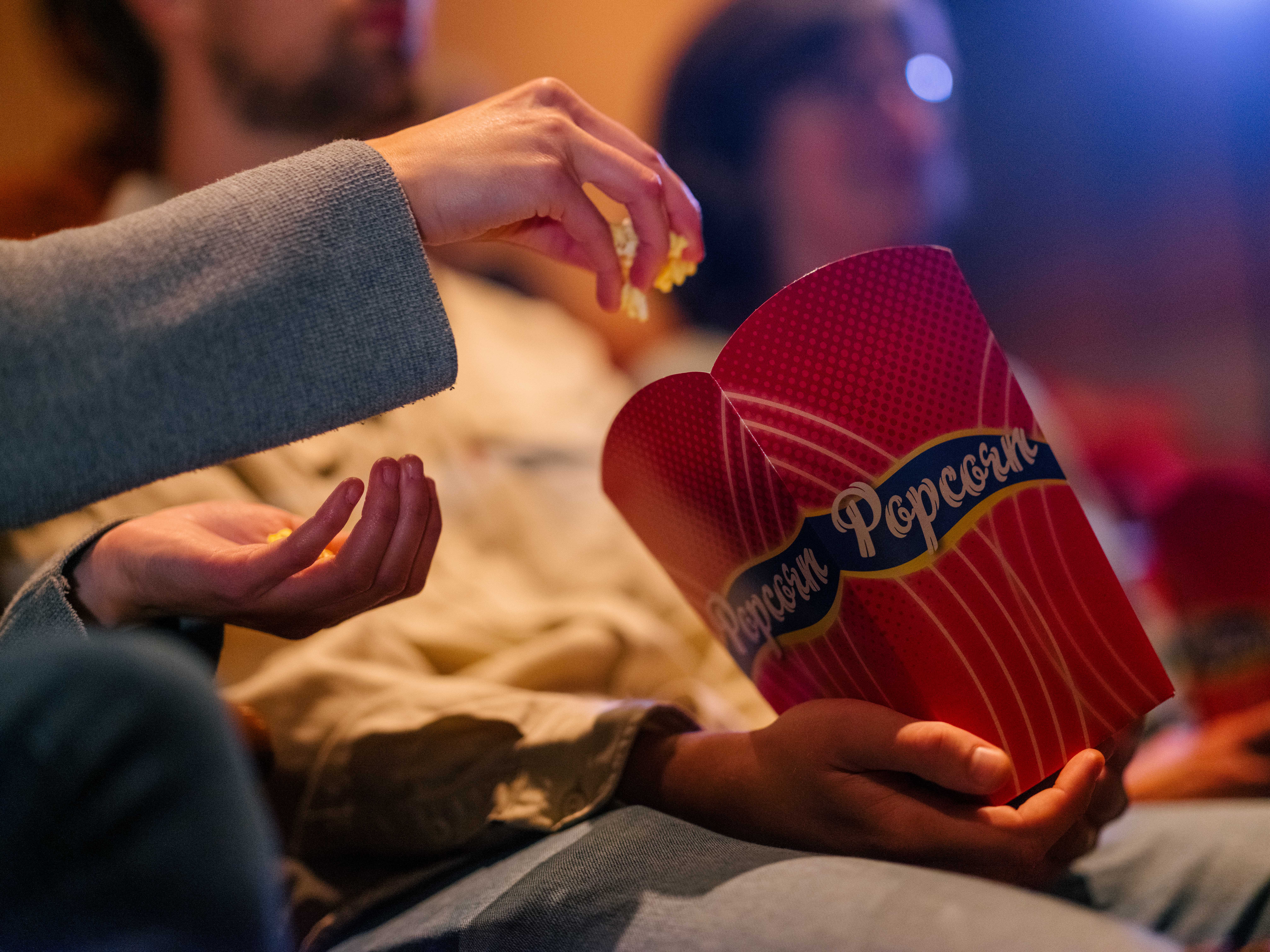 People enjoying film in a movie theater.