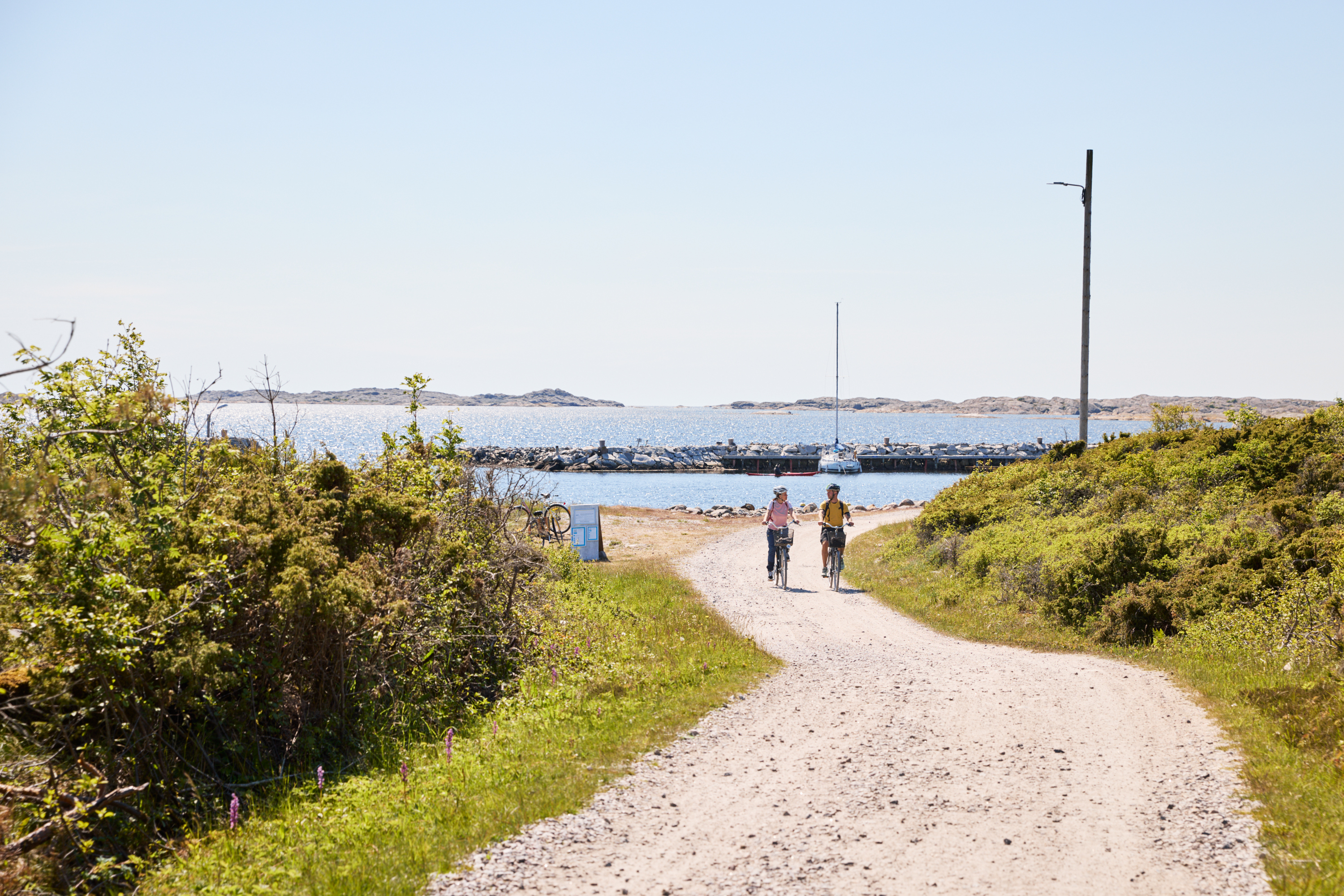 Two people are cycling on an island.