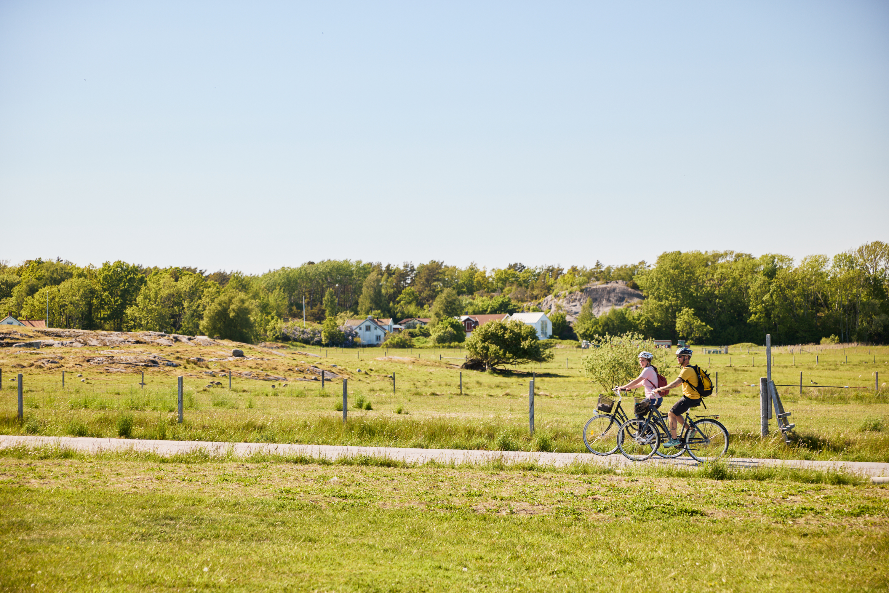 Two people are cycling on an island.