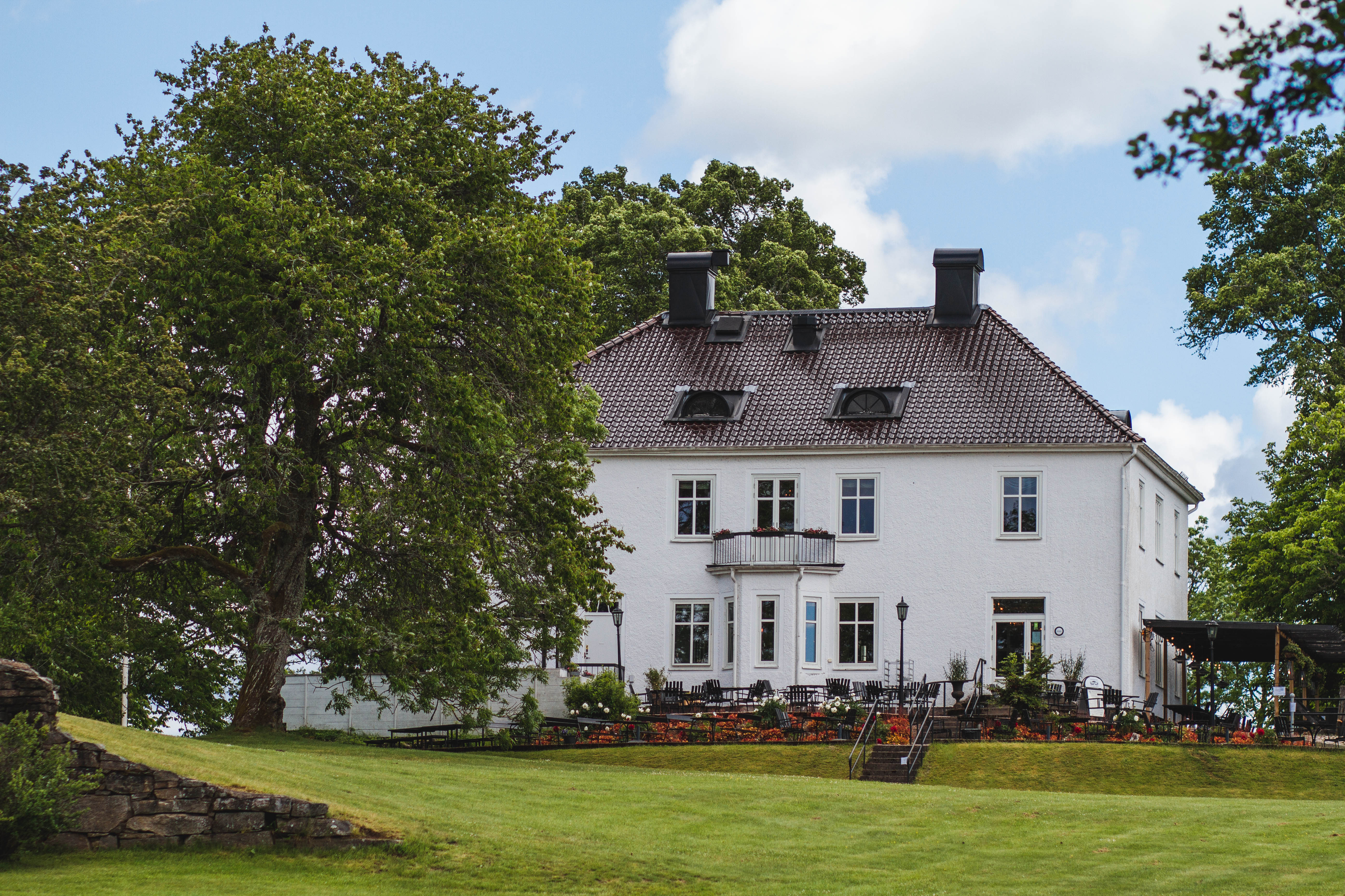 Manor building in greenery.