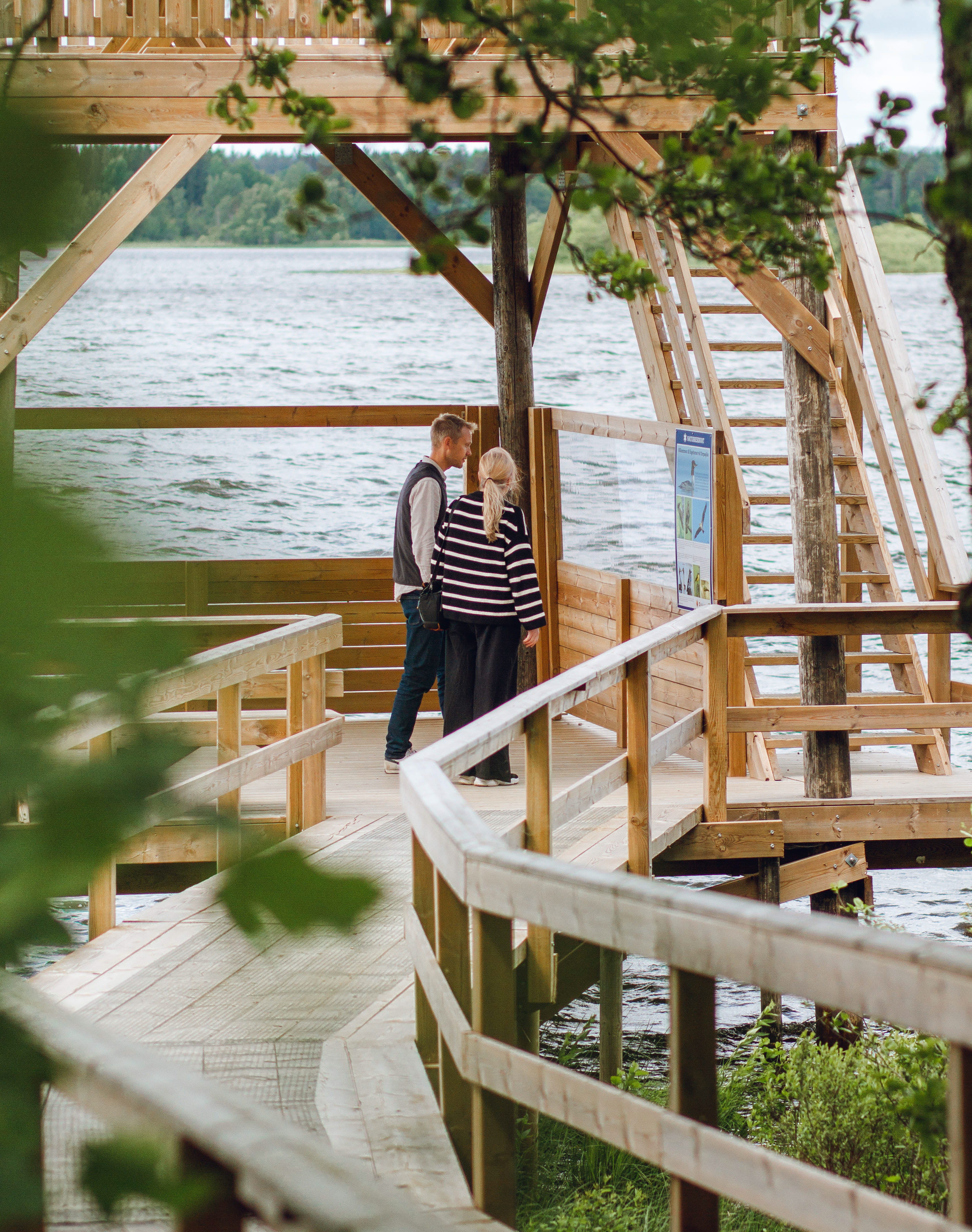 People walking by a lake.