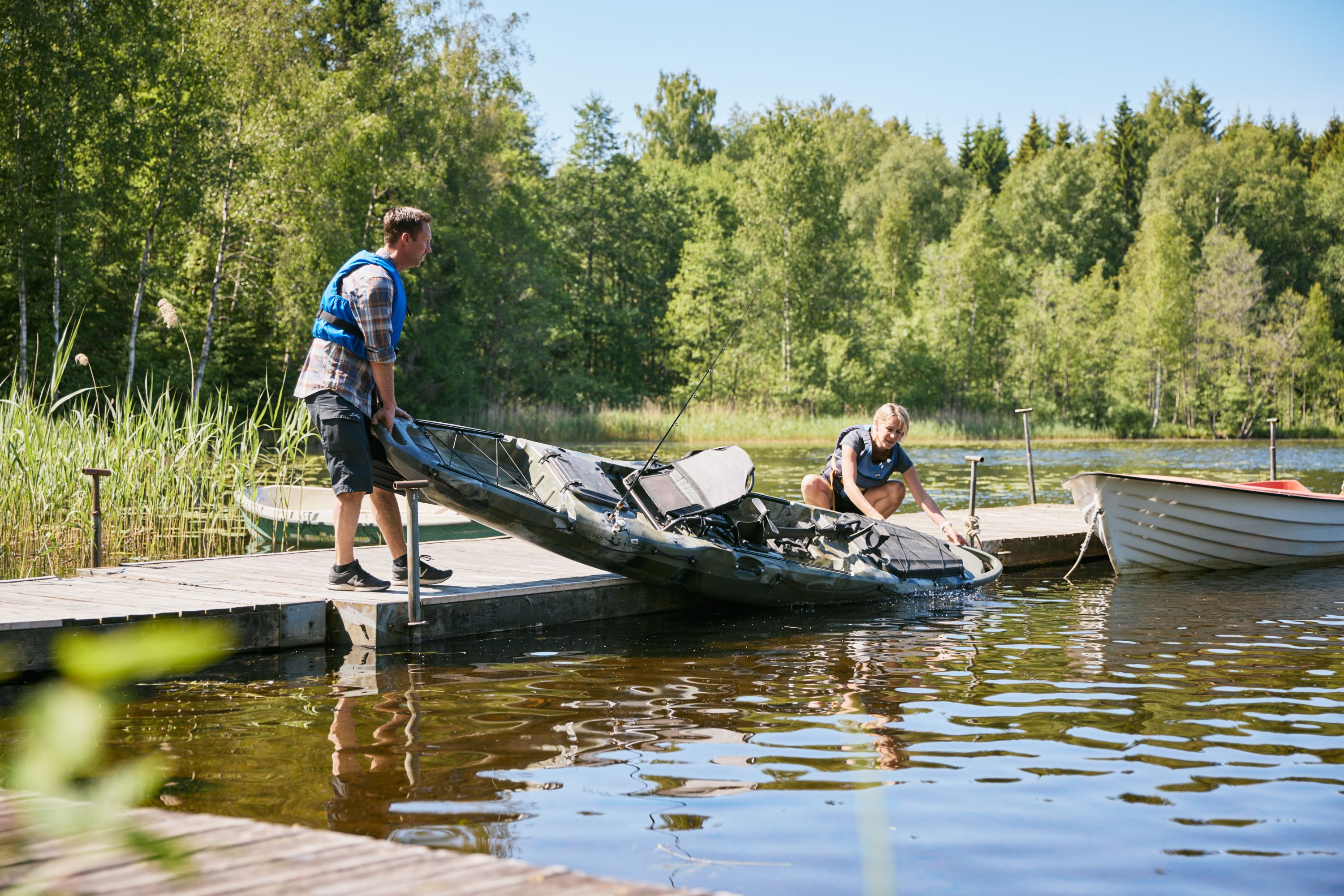 Man and woman fishing from a kayak.