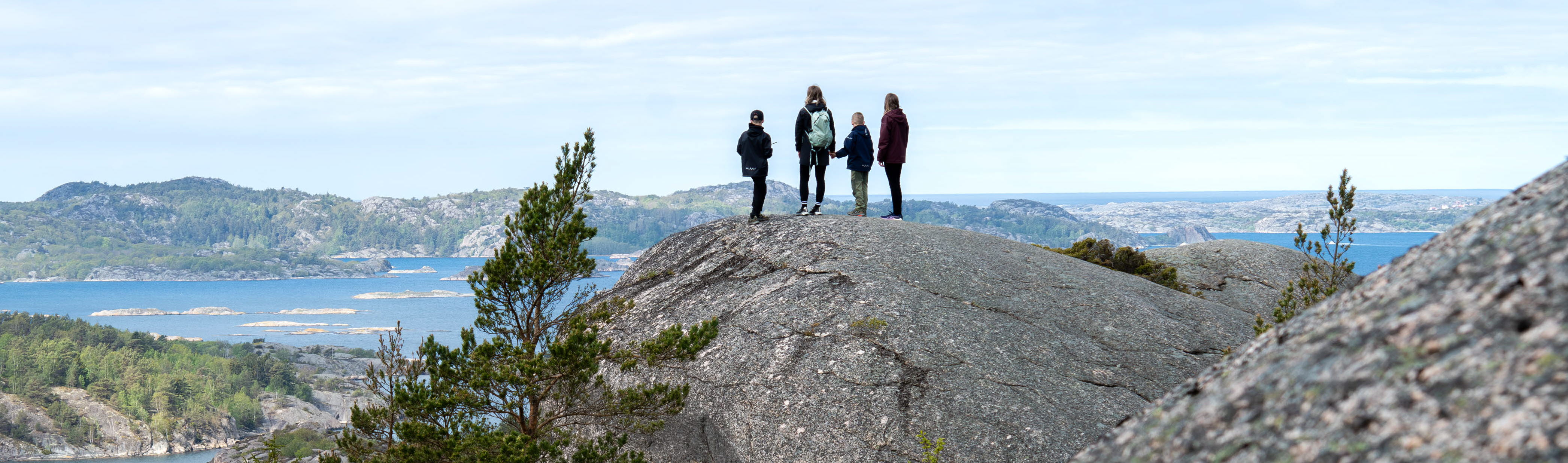 Family hiking on rocks.