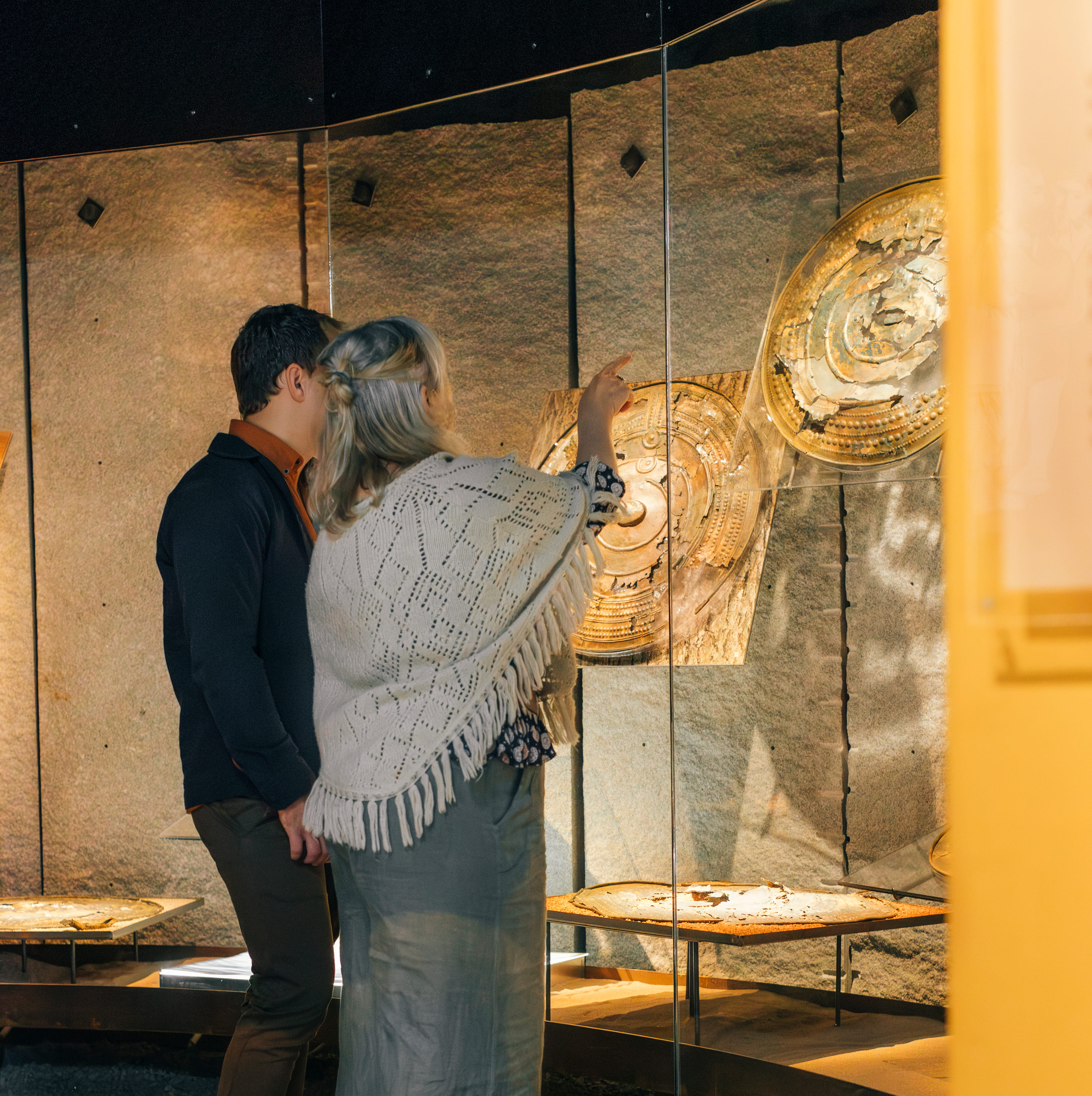 Museum visitors look at a historical exhibition.