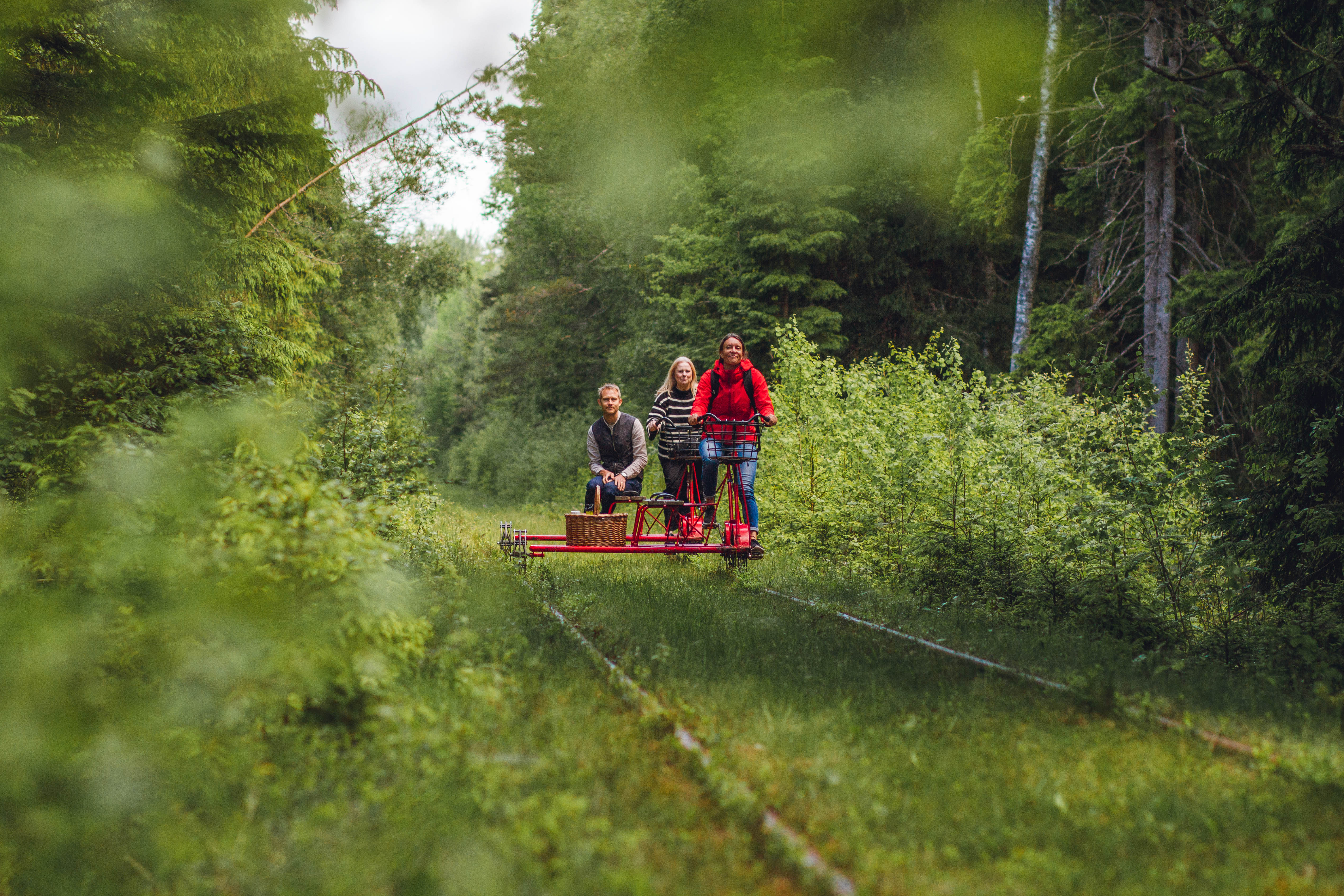 Friends on railway push trolley.