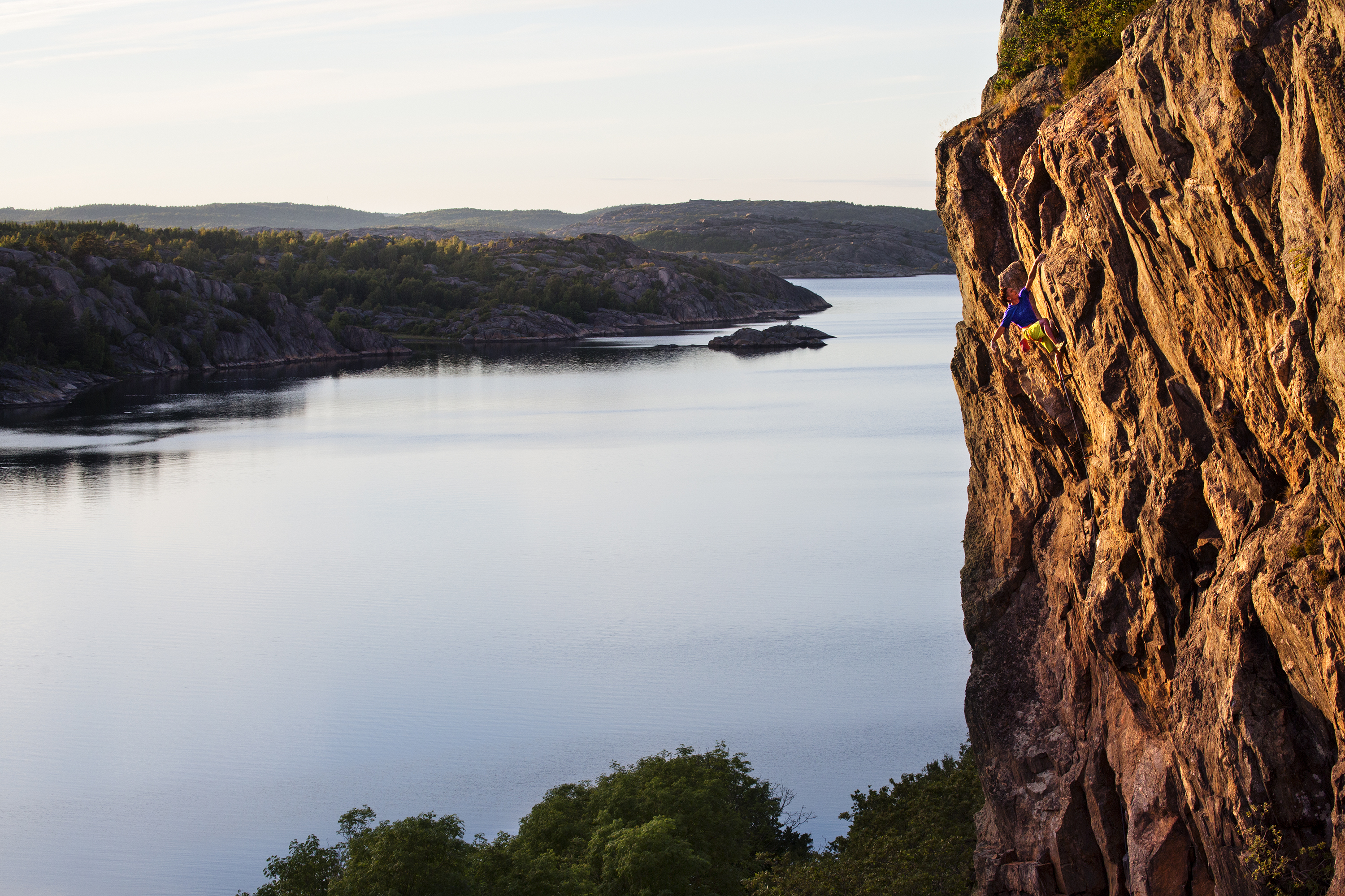 A man climbing on a massive cliff