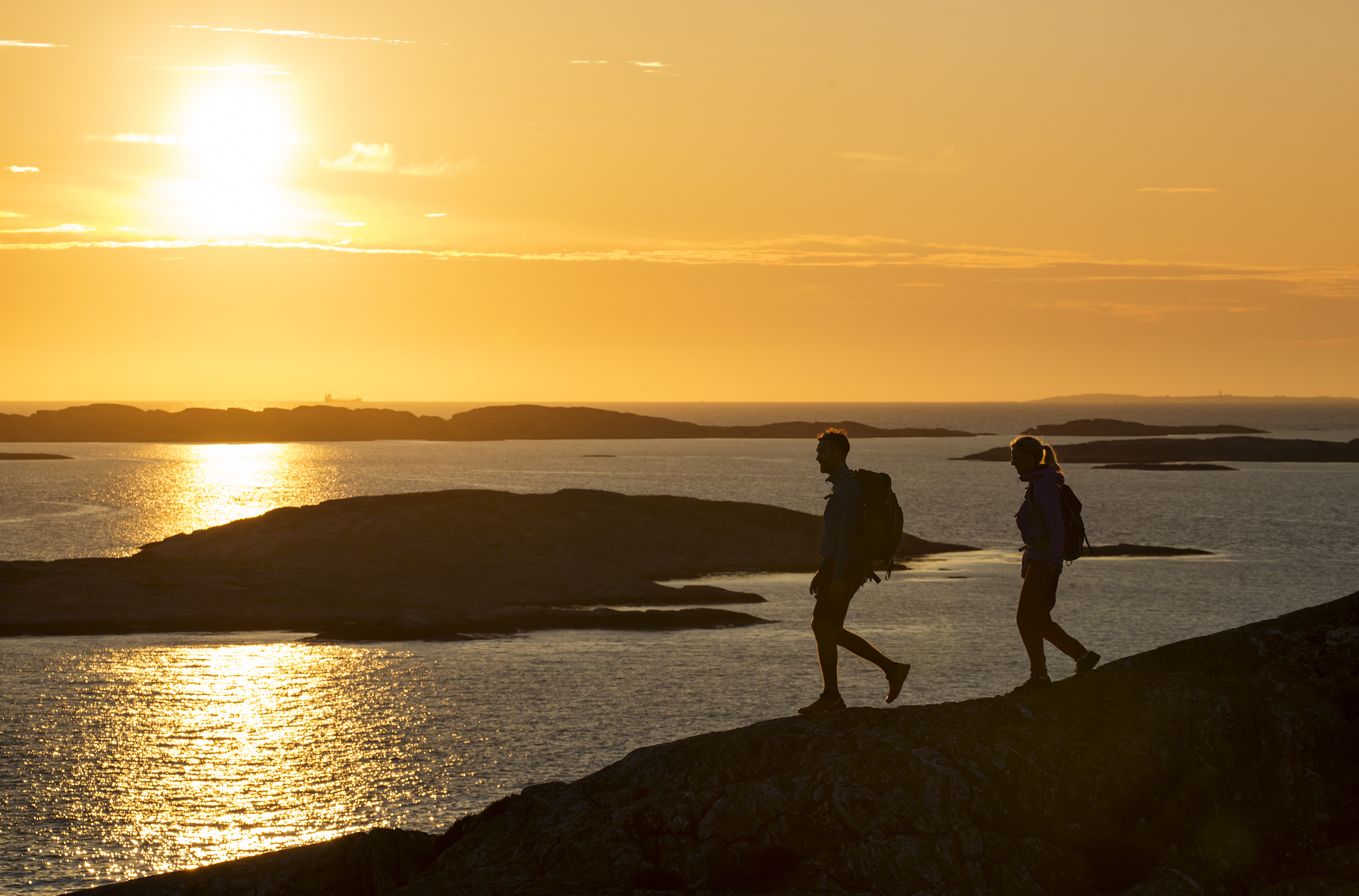 couple walking in the sun set