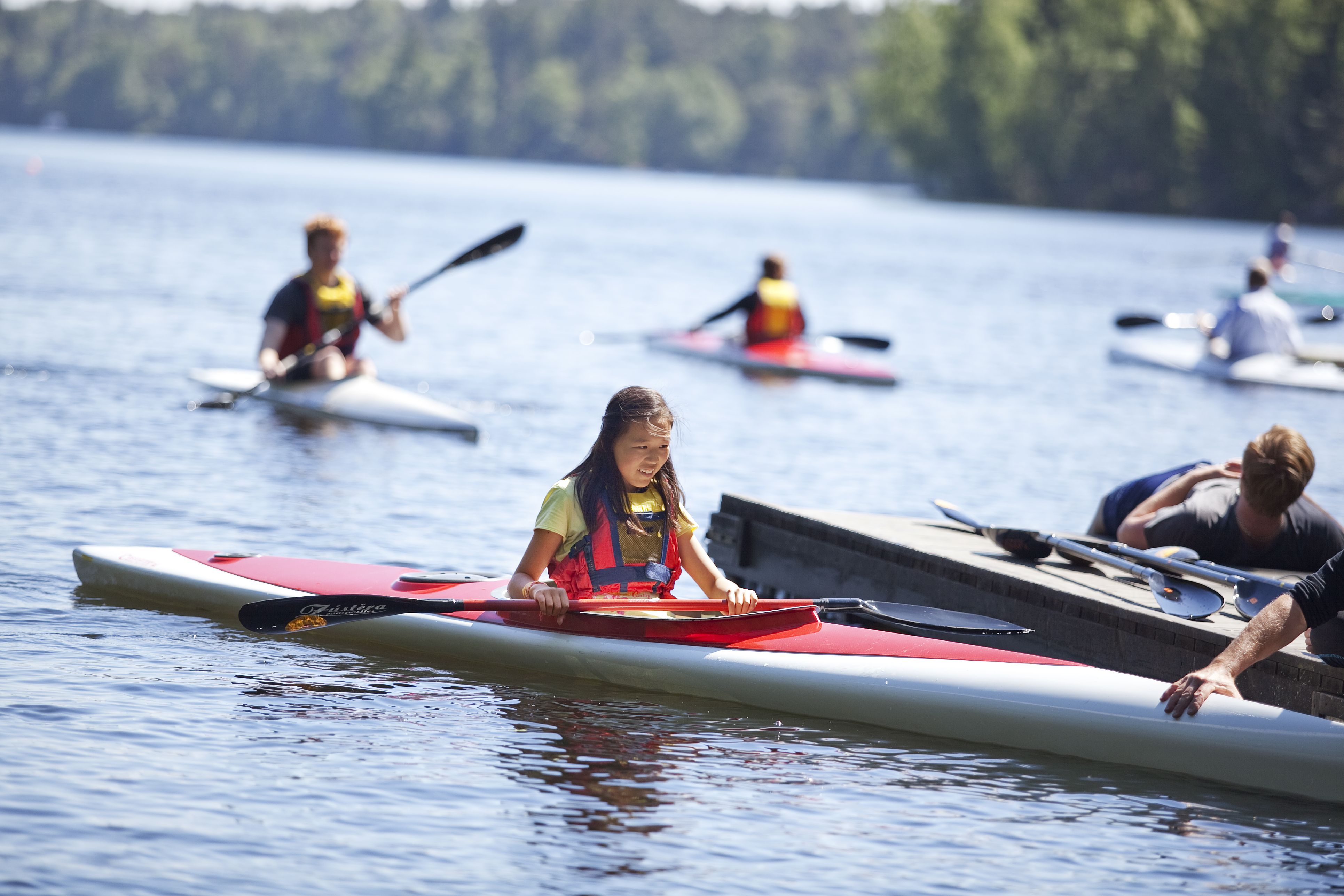 Girl kayaking in a lake.