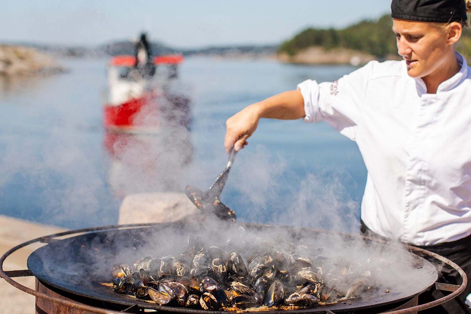 Woman preparing food outdoor.