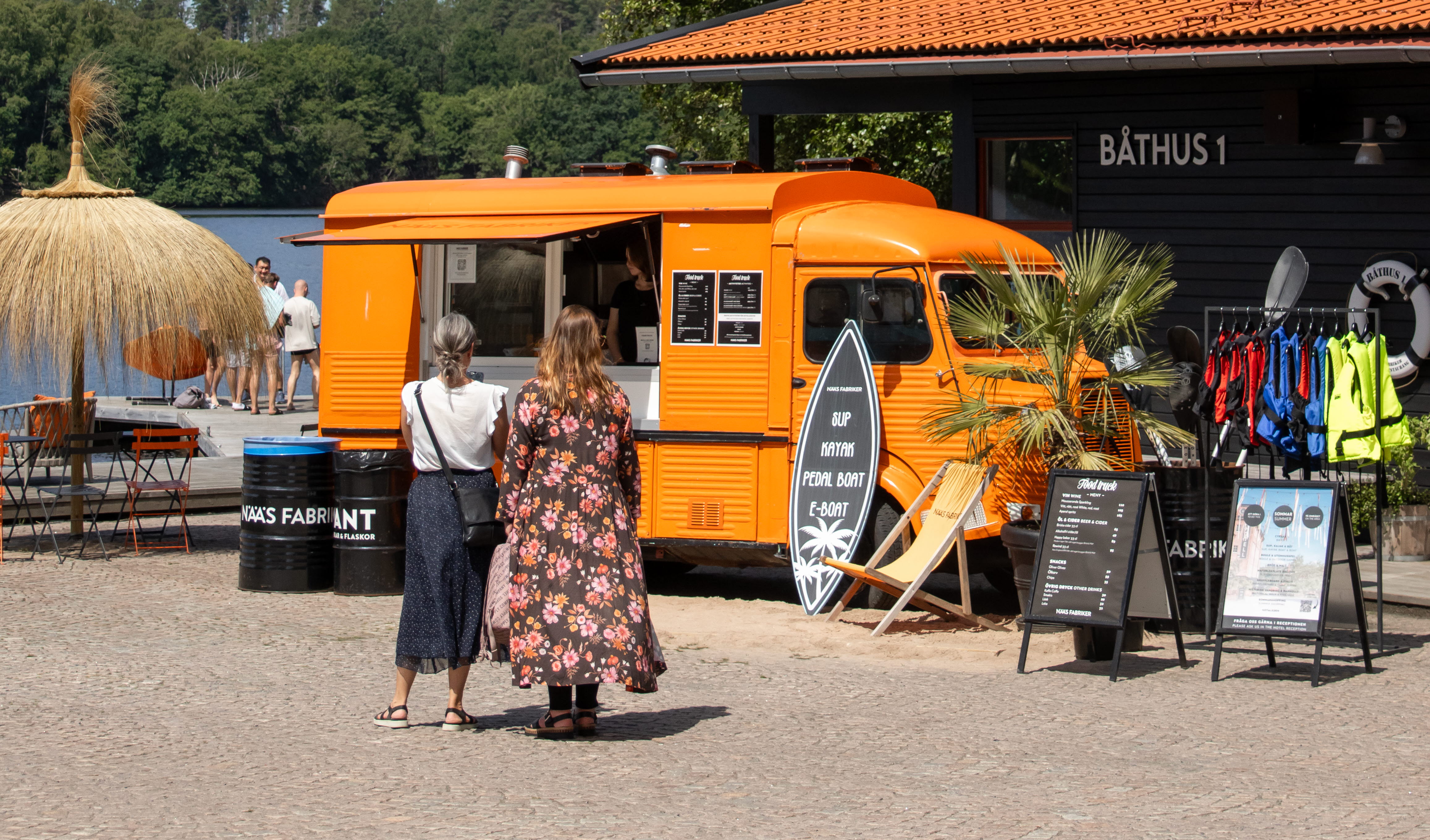 Two women walking towards a yellow car.