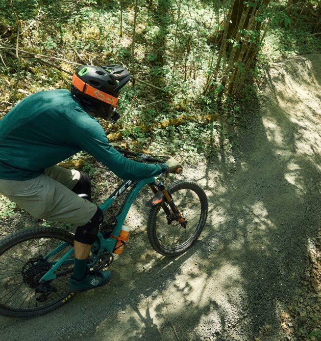 A man is cycling down a steep bike trail in the gravity zone.

