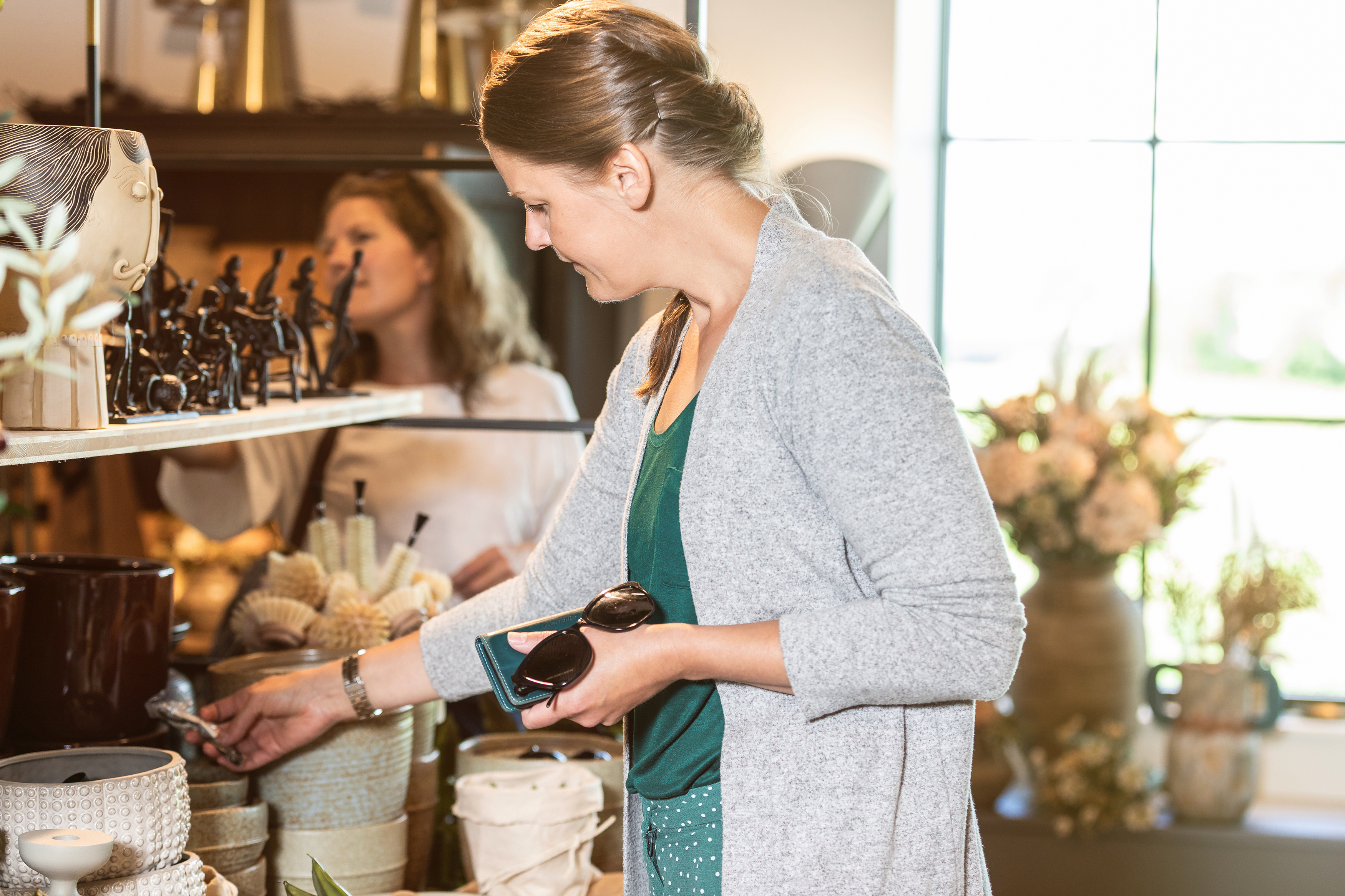 Woman peeking in an interior design store.