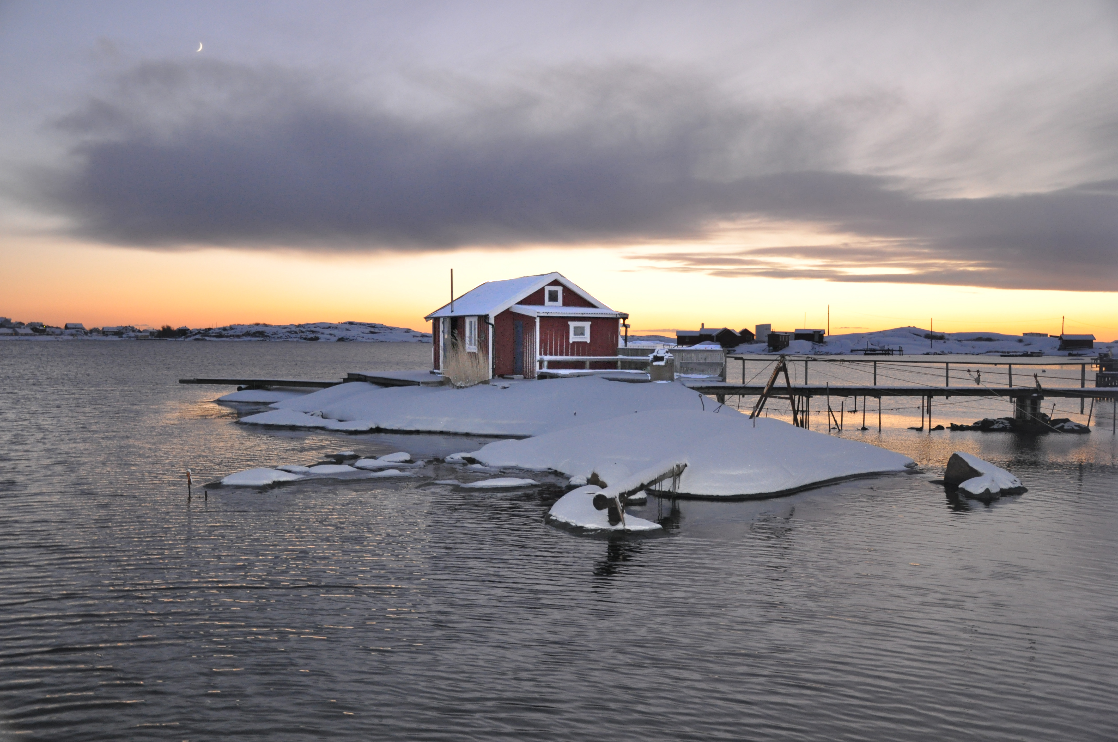 Boathouse in winter landscape