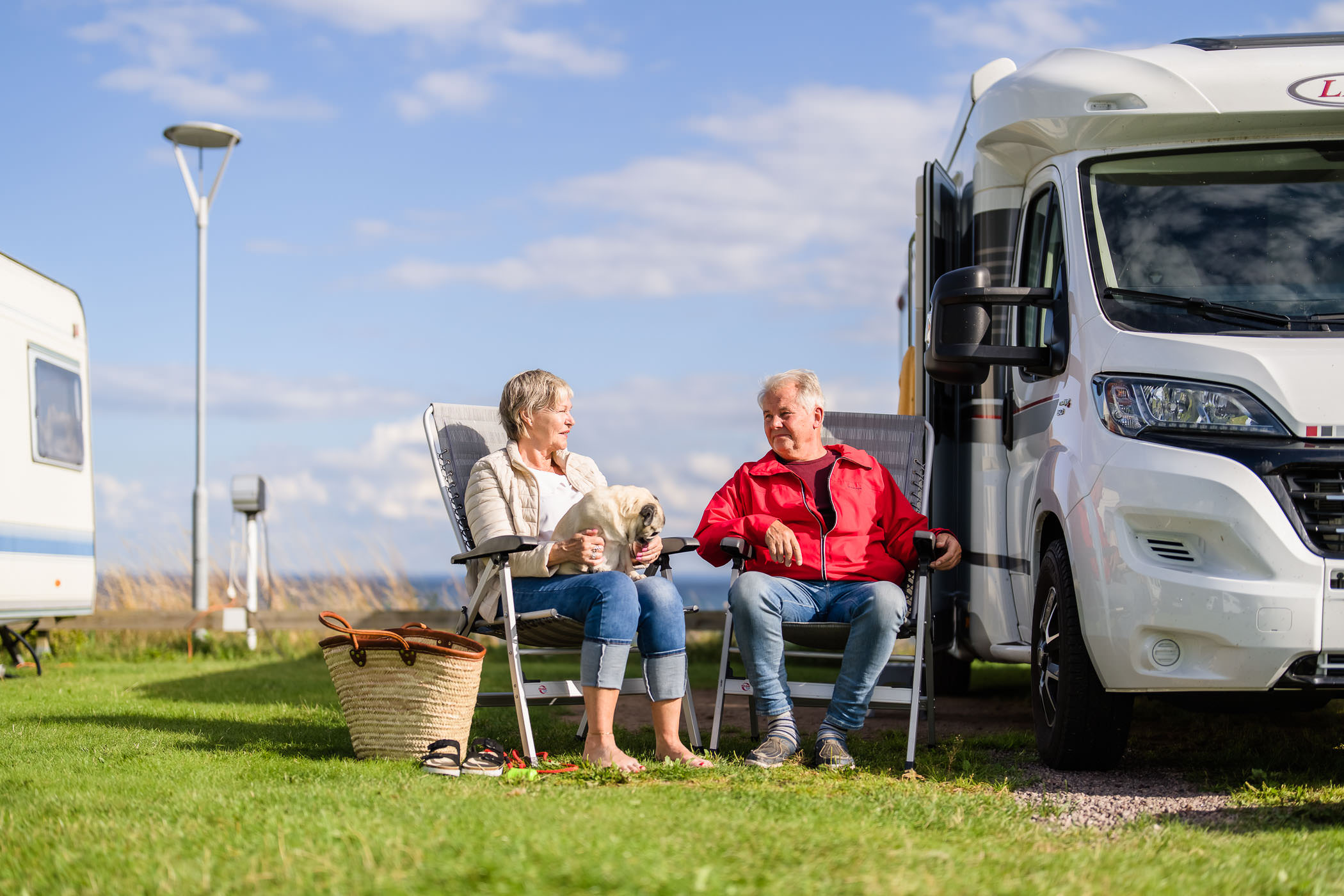 Couple sitting outside their campervan