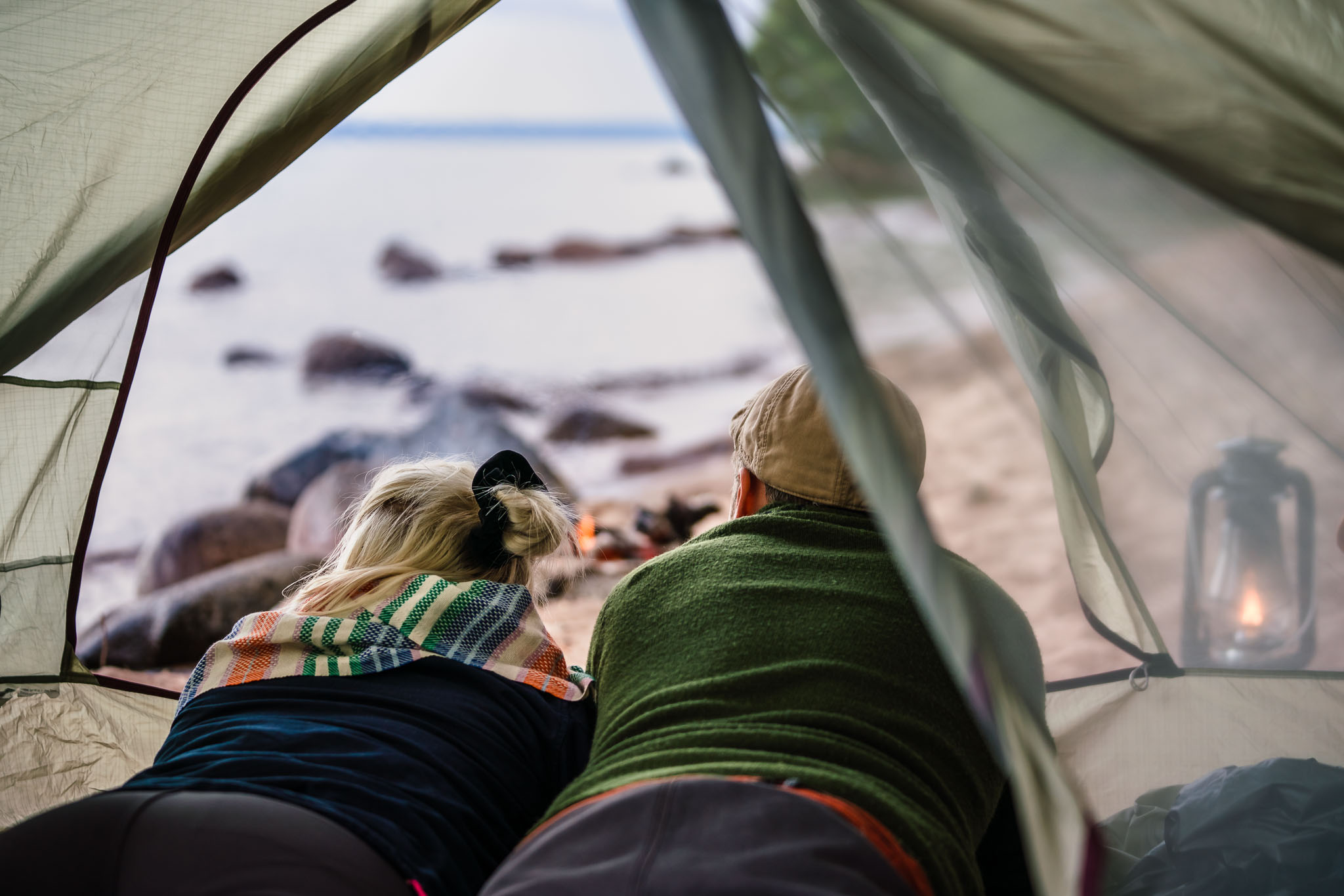 Couple in a tent on a Swedish beach, outside Hjo. 