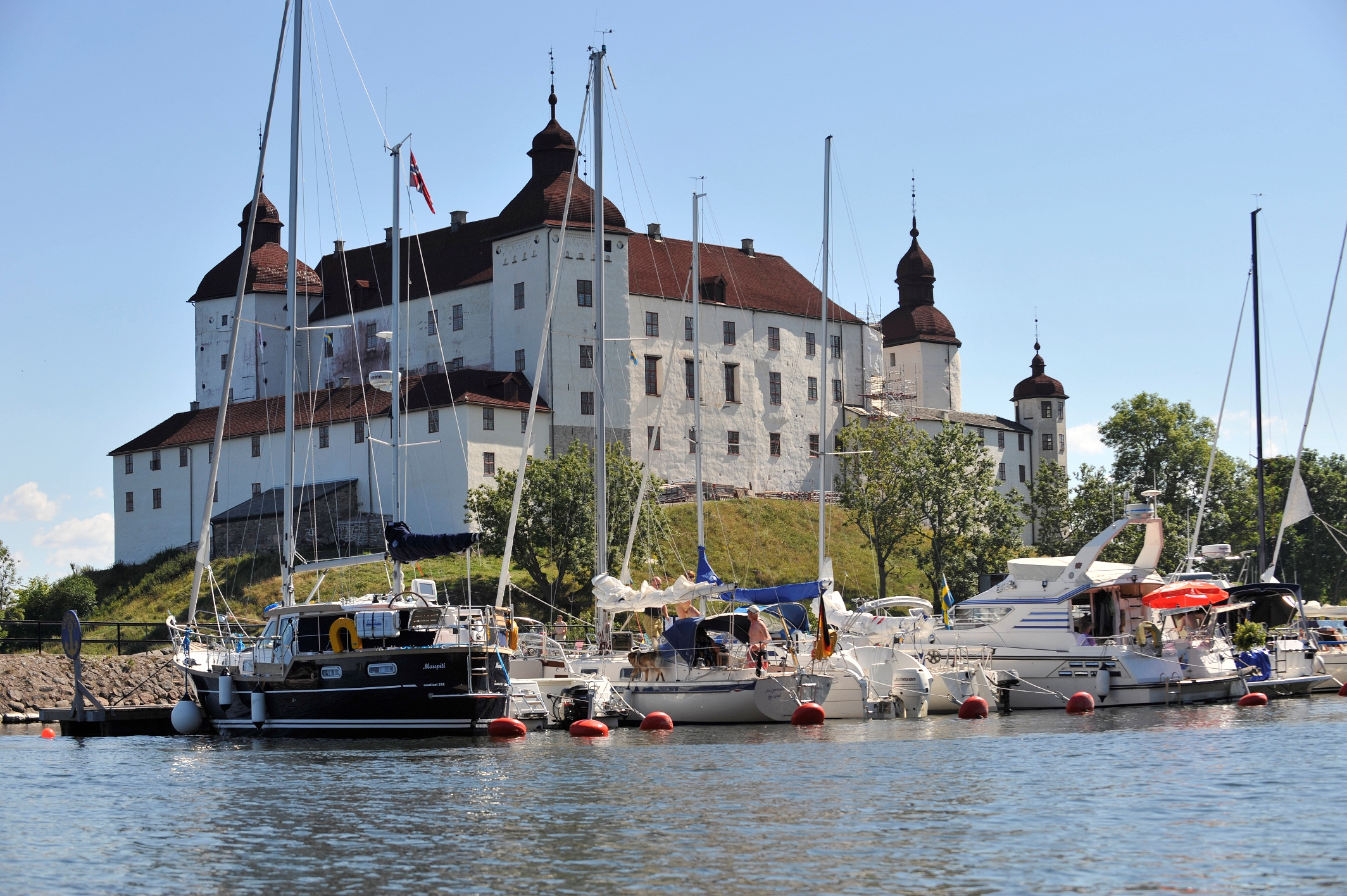 A guest harbor in front of a white castle.
