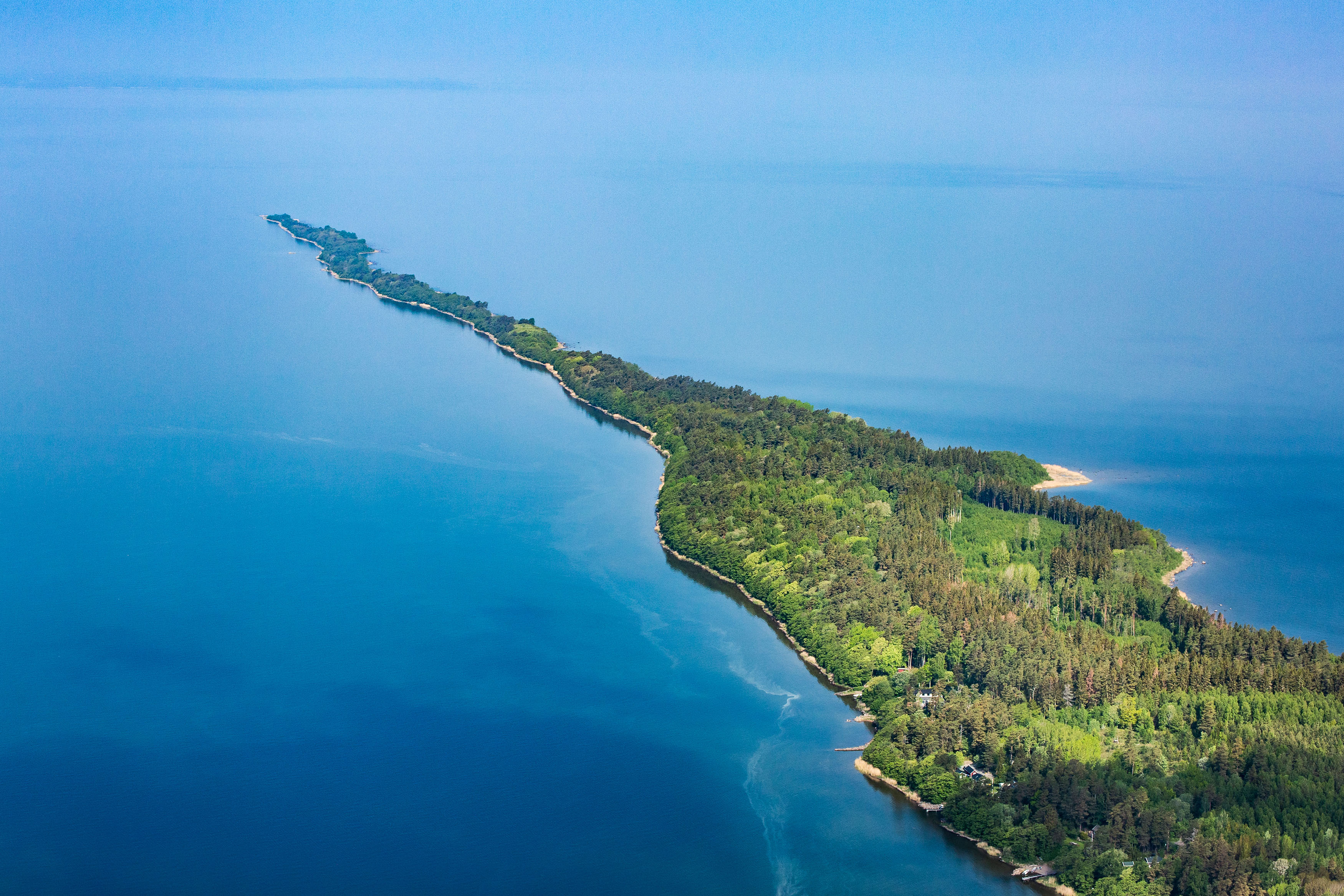 Aerial view of a reef sticking out in a lake
