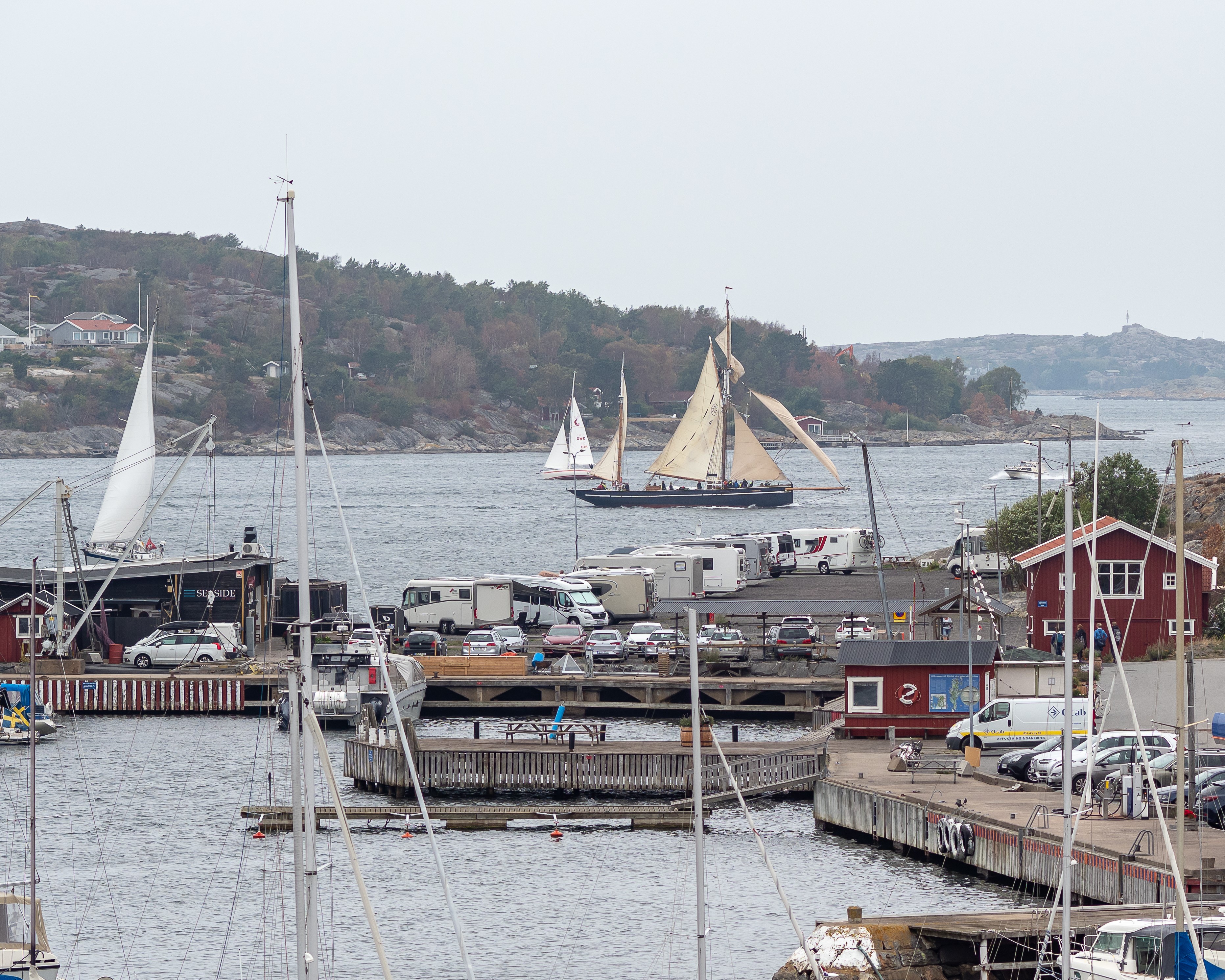 Björkö harbour and rv-park, a sailing ship at sea passing by