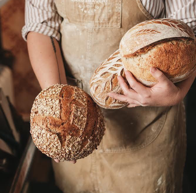 Person holding bread.