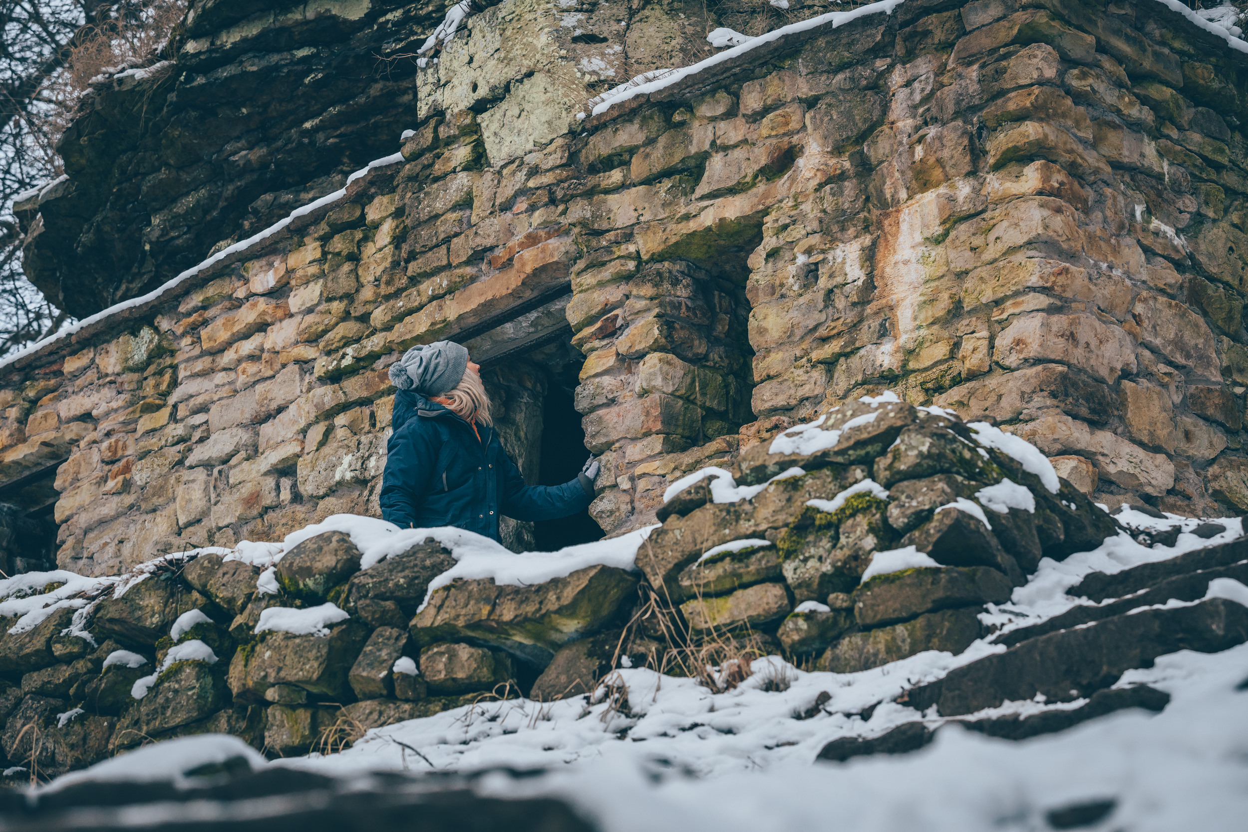 A woman looking at a cave
