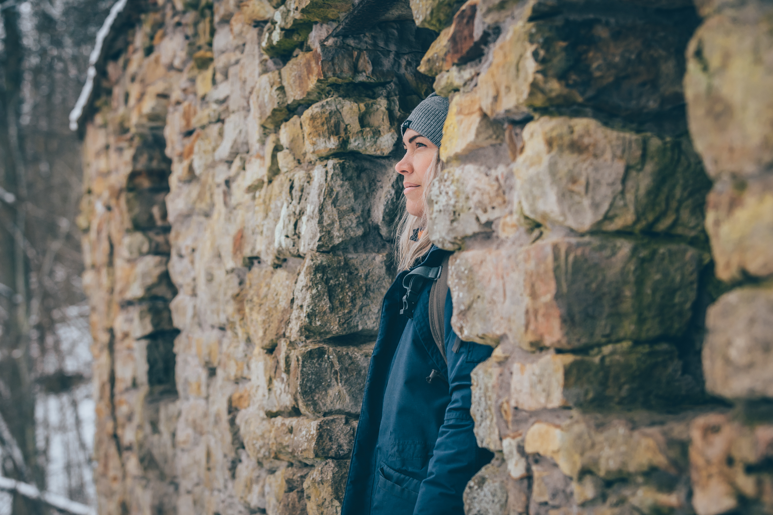 A woman looking out of a cave

