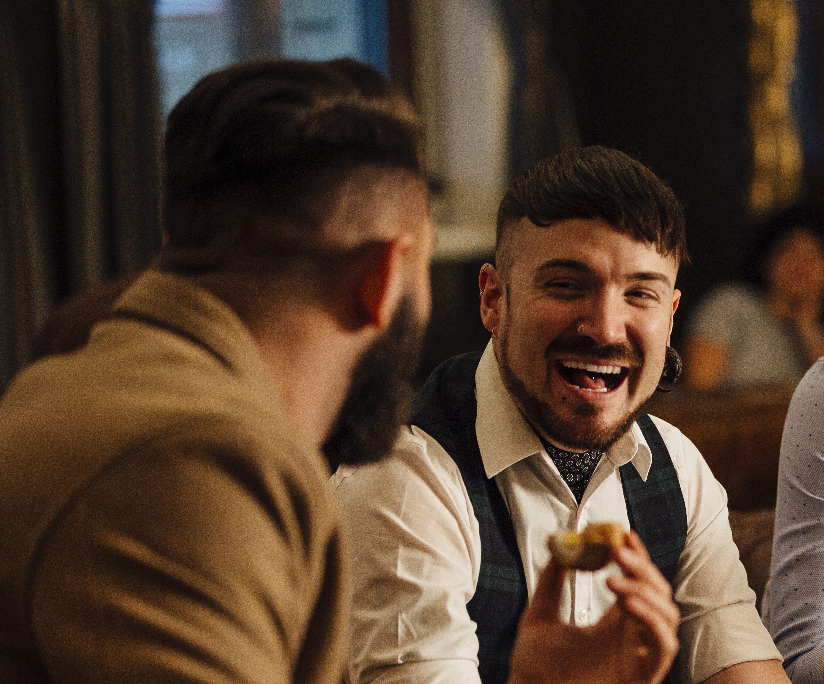 
Three males sitting together eating at a restaurant