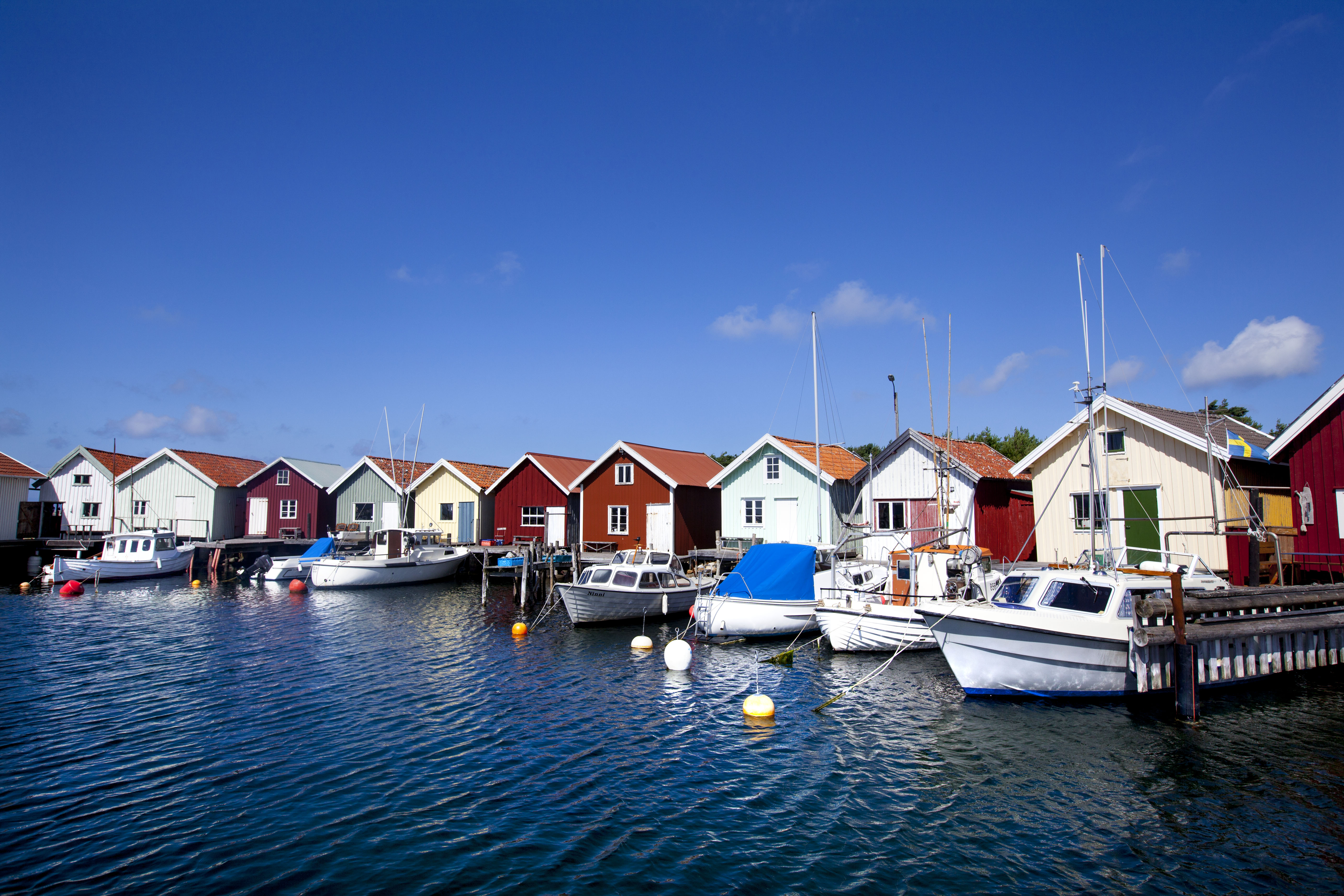 Boat houses with anchored small boats at the docks on North Koster.