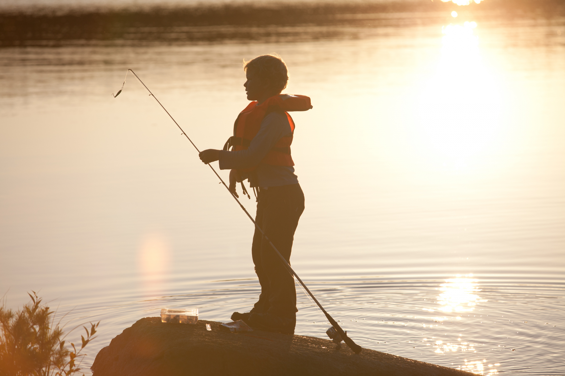 child fishing sunset