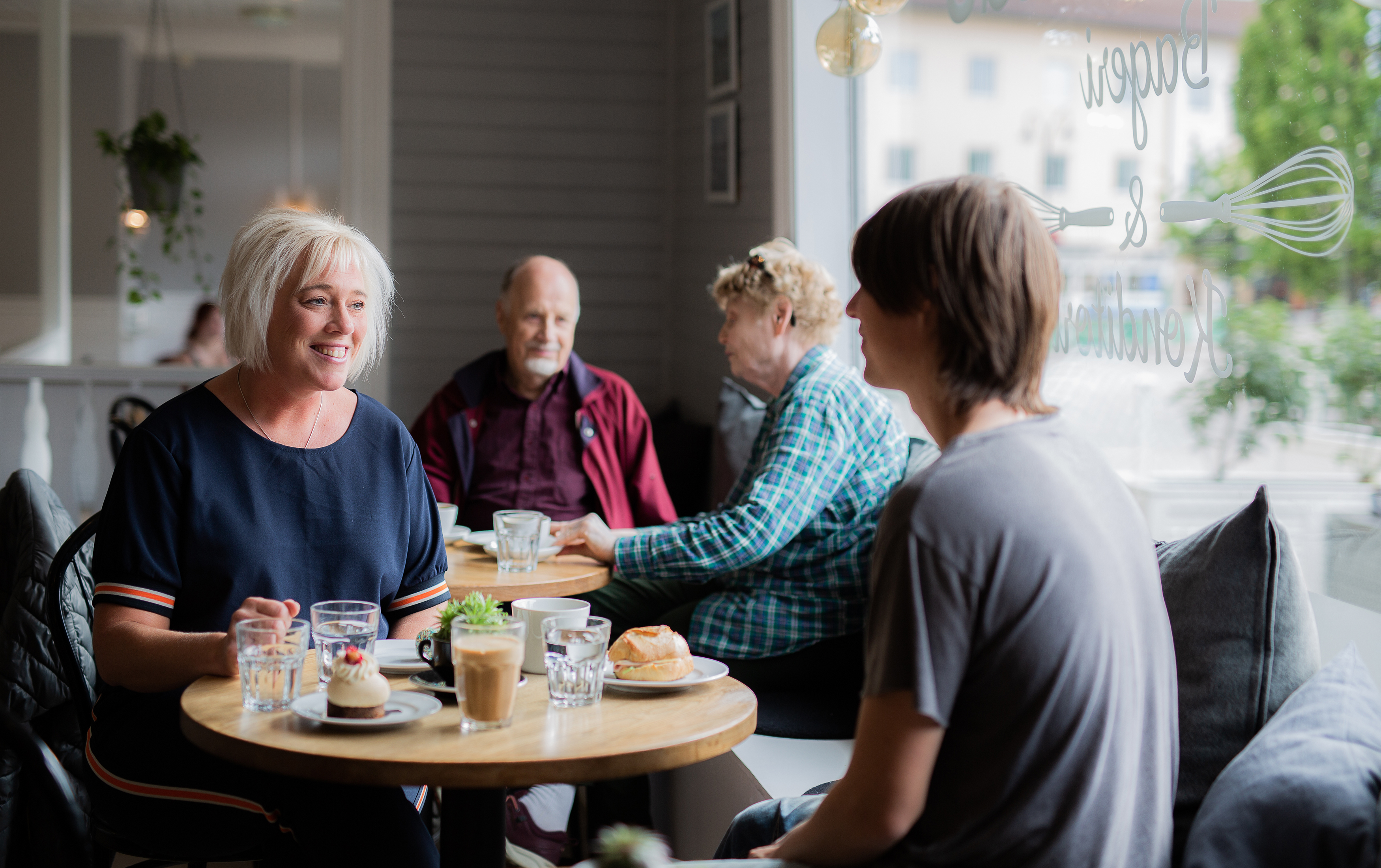 
People drinking coffee at a cafe in Tidaholm center.