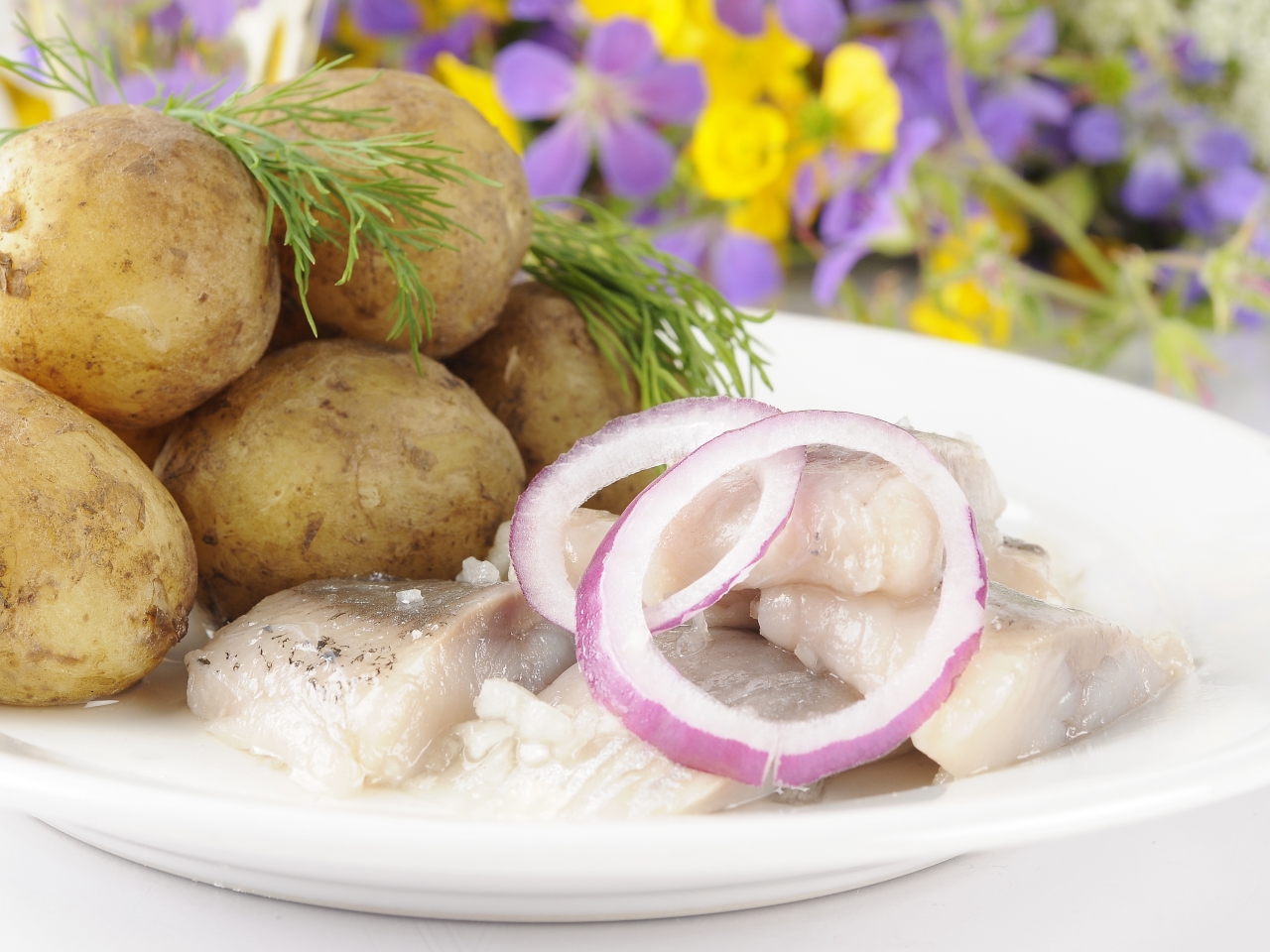 Plate with herring and fresh potatoes.