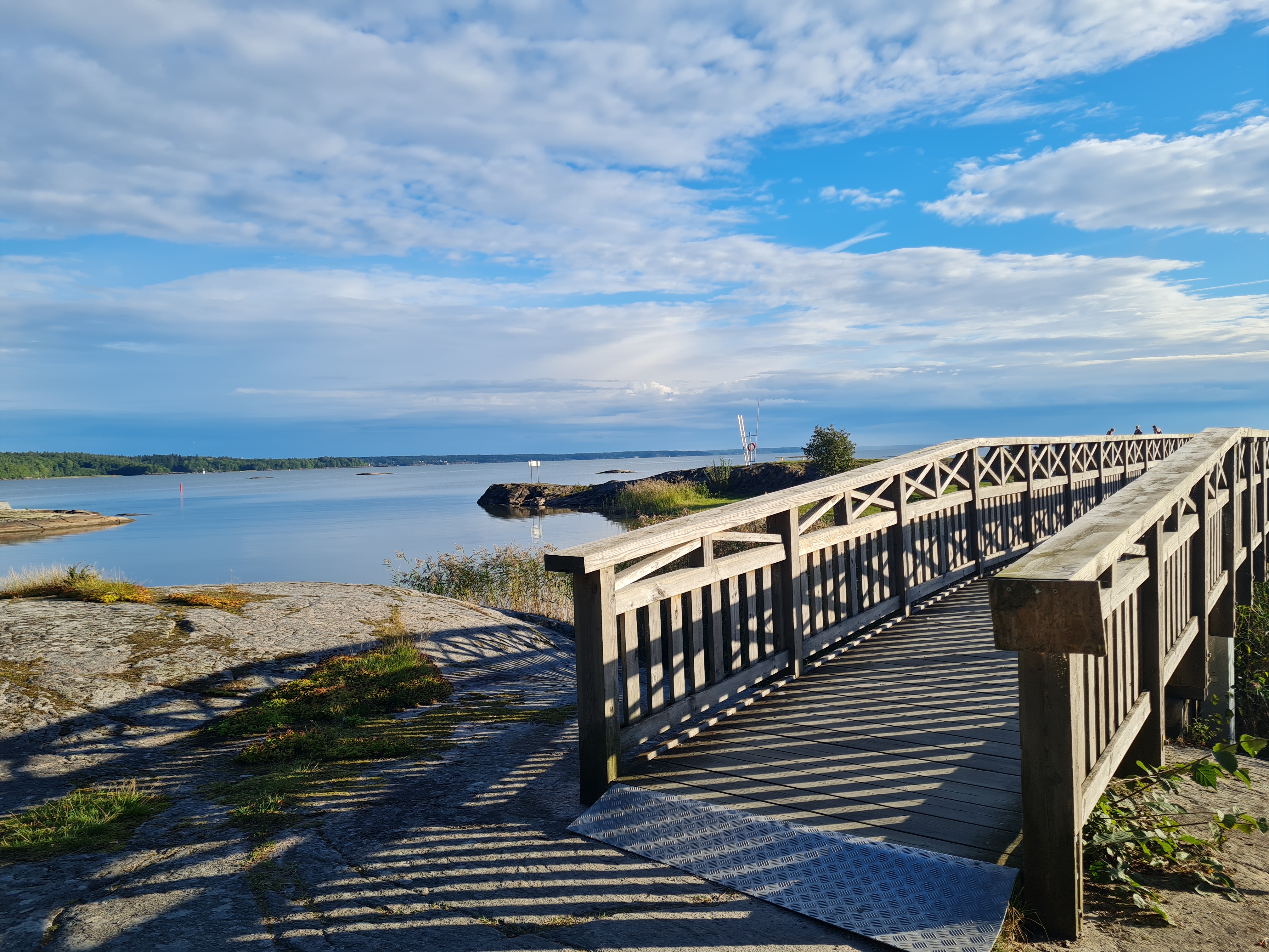 Wooden bridge over rocks by the water