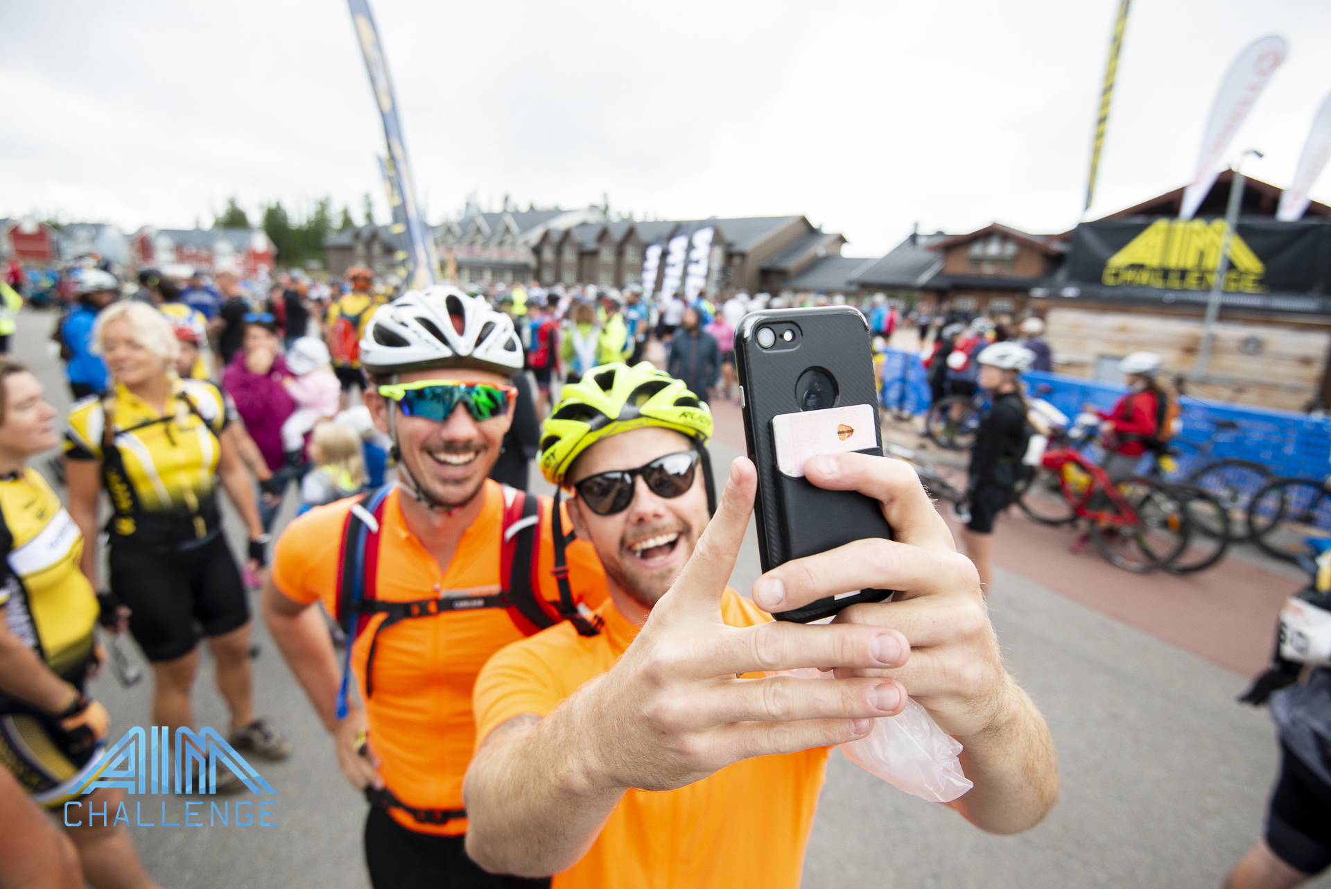 Two people taking a picture as a selfie before a bike competition
