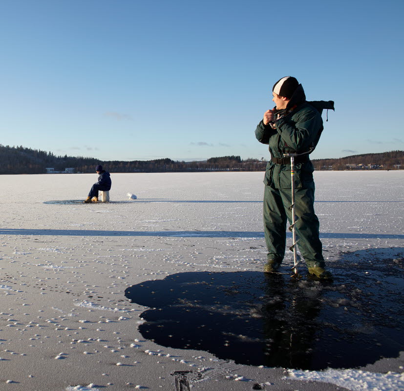Three persons on a frosen lake